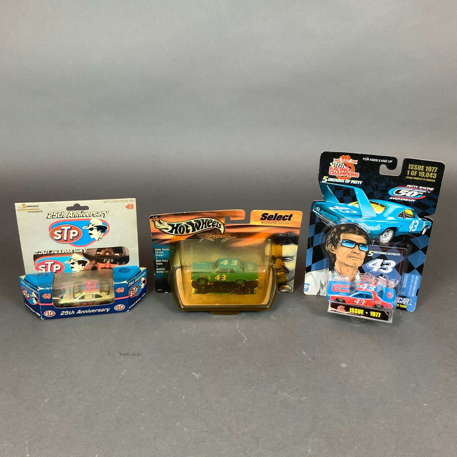 3pc Richard Petty NASCAR 1:64 Scale Die-Cast Model Cars Including Action Performance, Hot Wheels,: This lot consists of three 1:64 scale die-cast model cars honoring the career of NASCAR driver Richard Petty, all contained in original retail packaging. The collection includes an Action Performance 