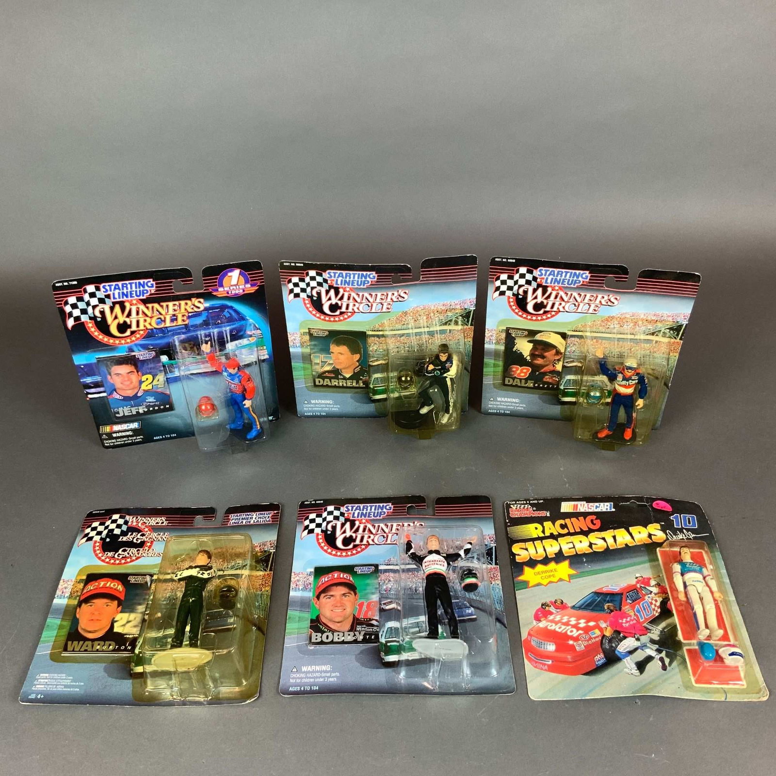 Six Winners Circle & Racing Champions Vintage NASCAR Action Figures: This collection consists of six vintage NASCAR driver action figures, all preserved in their original factory-sealed blister packaging. The group includes five figures from the Starting Lineup Winner'
