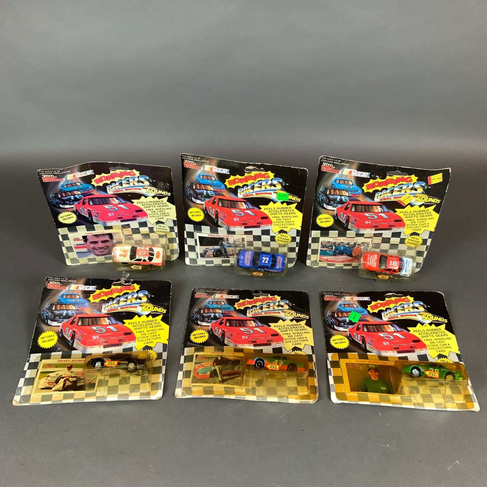 7pc Racing Champions Roaring Racers NASCAR Stock Car Models: A 7pc collection of vintage Racing Champions Roaring Racers NASCAR stock car collectible models. These 1:64 scale vehicles are from the Real Engine Sounds series and feature die-cast metal bodies with