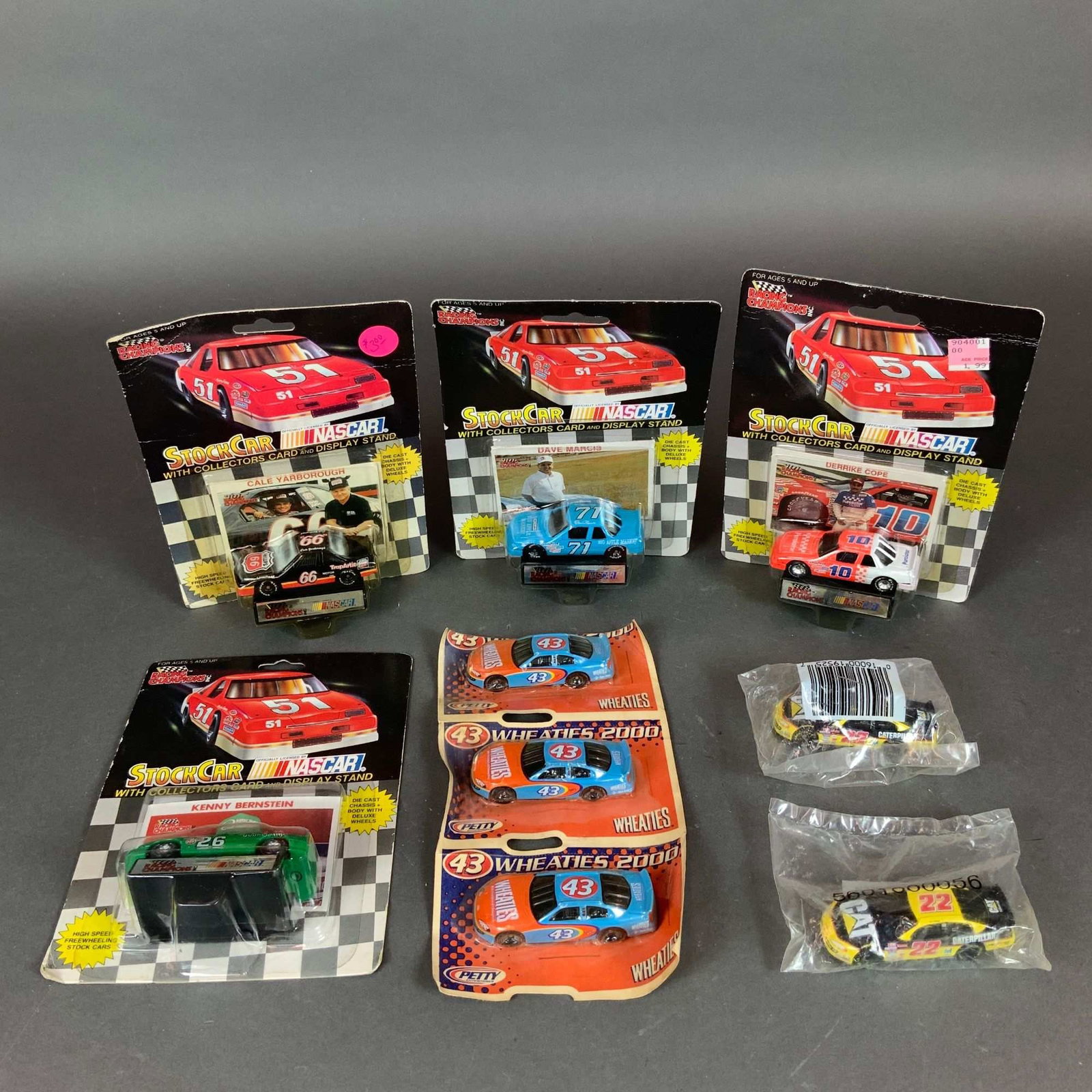 9 NASCAR Racing Champions & Promotional Die-Cast Model Cars: This lot consists of nine NASCAR die-cast model cars from various series and promotional releases. Included are four 1/64 scale vehicles from the Racing Champions Stock Car series, each in its origina