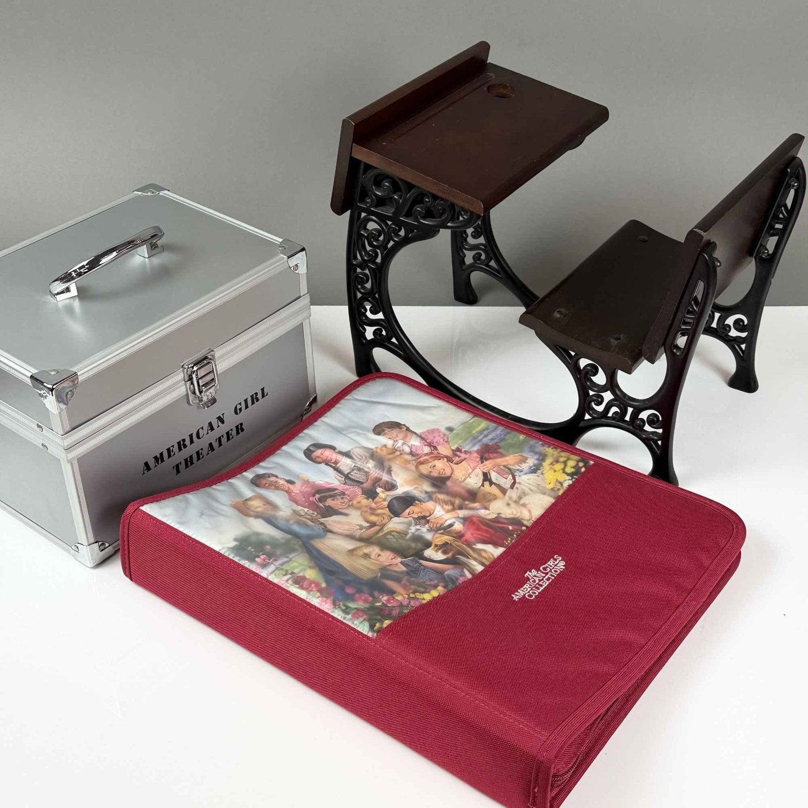 3pc American Girl Grouping Including Desk, Binder Case, and Make-up Case: A three-piece collection of accessories from The American Girls Collection, scaled for 18-inch dolls. The grouping includes a miniature historical-style school desk featuring ornate black-finished cas