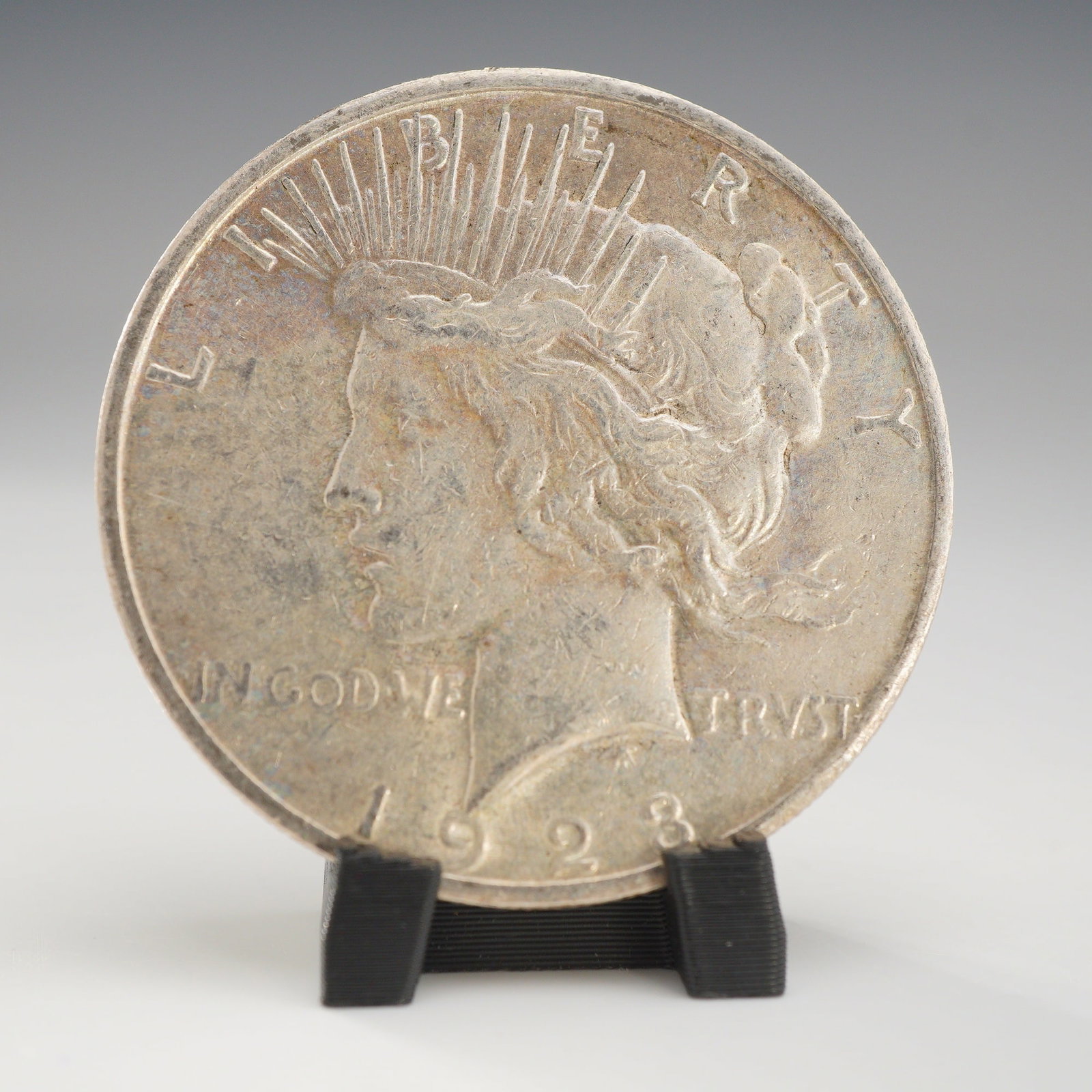1923-S US Peace Silver One Dollar Coin, Circulated: A 1923 United States Peace silver dollar struck at the San Francisco Mint. This 90% silver Peace silver dollar features the Peace Dollar obverse and reverse designs. The coin is composed of 90% silver