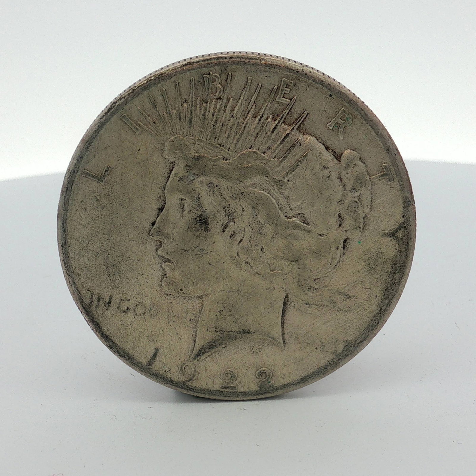 US 1922-S Silver Peace Dollar: This US silver Peace dollar is dated 1922 and was struck at the San Francisco Mint. It features the standard Peace dollar type obverse and reverse. Obverse inscriptions include LIBERTY, IN GOD WE TRVS