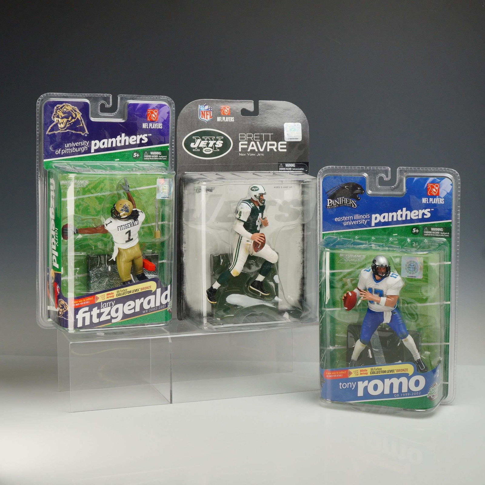 Three McFarlane Toys NFL and College Football Action Figures, Fitzgerald, Favre, and Romo (1 of 3)