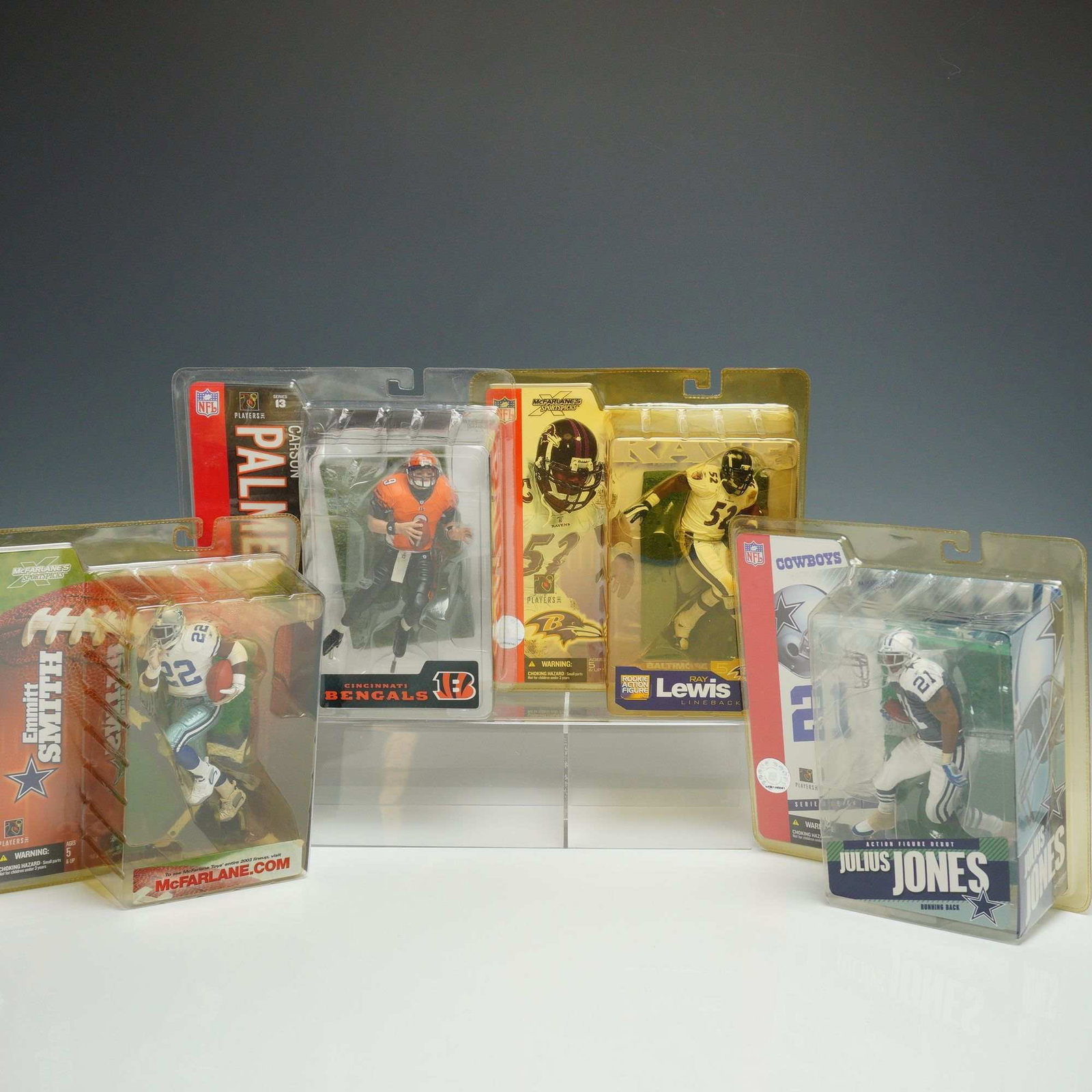 A 4pc Lot of McFarlane Toys NFL SportsPicks Action Figures: A collection of four NFL SportsPicks action figures produced by McFarlane Toys, each in its original, unopened blister pack packaging. The group includes Carson Palmer of the Cincinnati Bengals from S