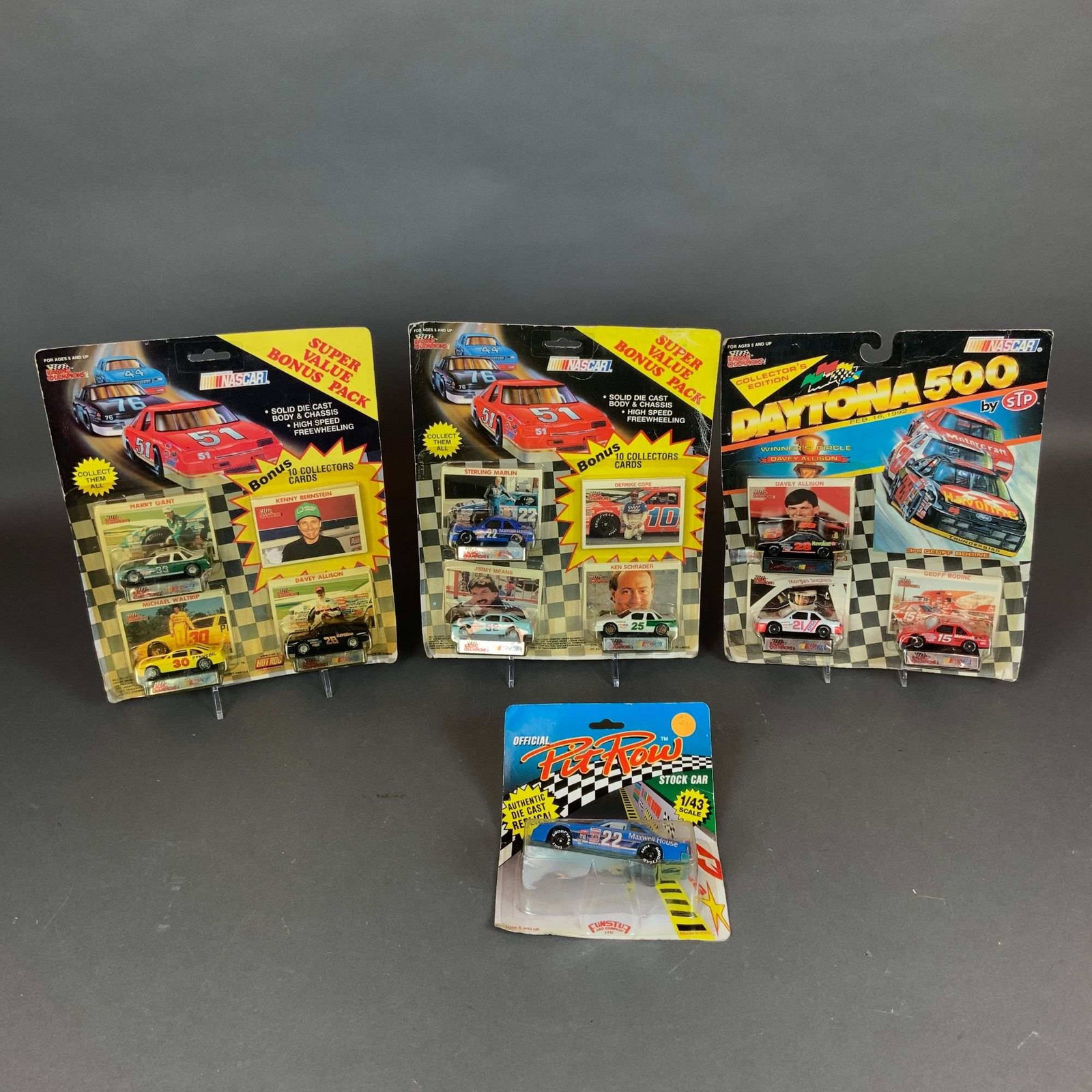 An Assortment of Four Vintage NASCAR Model Cars and Die-Cast Sets: A collection of four vintage NASCAR die-cast model car sets in their original retail packaging, featuring items by Racing Champions and Funstuf. The lot includes two Racing Champions Super Value Bonus