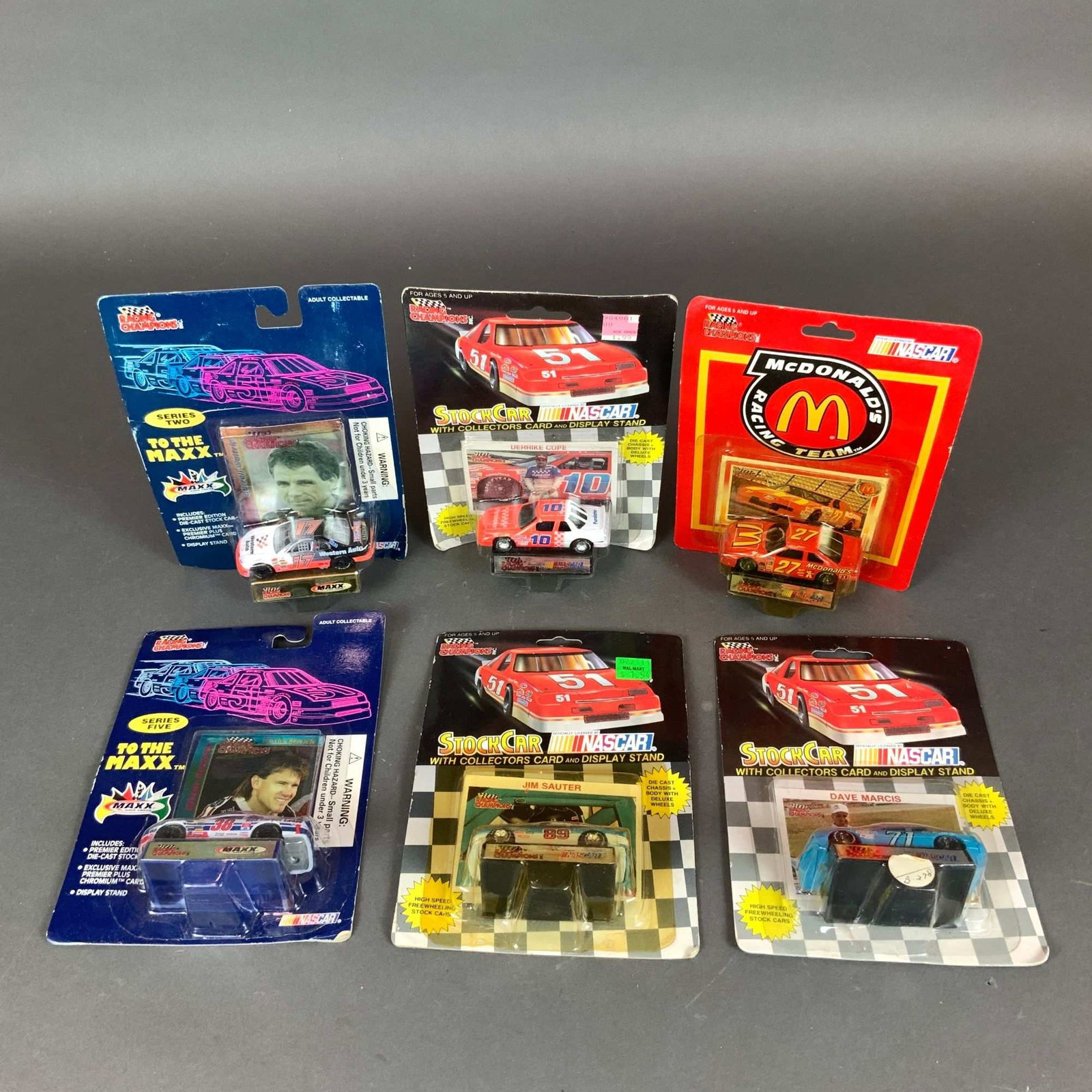 6pc Racing Champions 1/64 NASCAR Die-Cast Stock Car Models: A collection of six vintage 1/64 scale die-cast NASCAR stock cars manufactured by Racing Champions Inc. Each model is housed in its original factory blister pack packaging, which includes a collector 