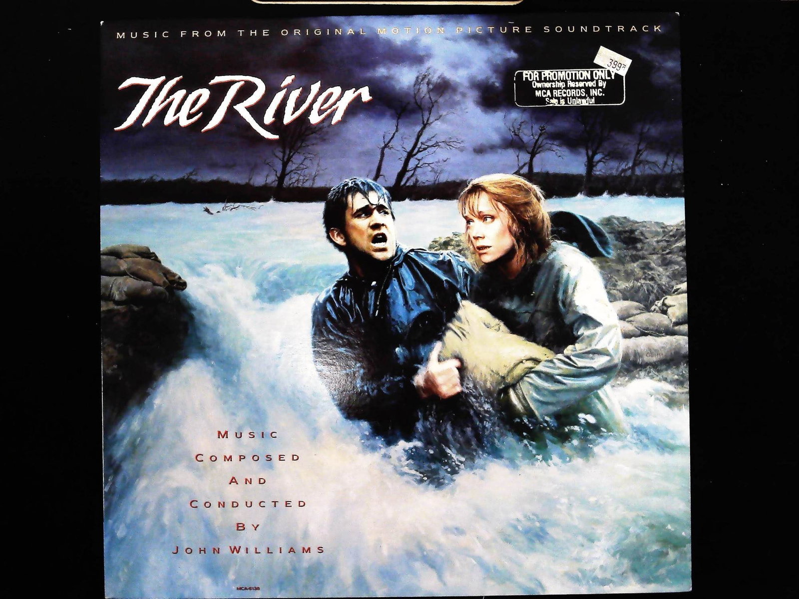 John Williams The River Original Motion Picture Soundtrack Promotional Vinyl LP MCA-6138: This is an original motion picture soundtrack for the 1984 film The River, featuring music composed and conducted by John Williams. The long-playing vinyl record was manufactured and distributed in th
