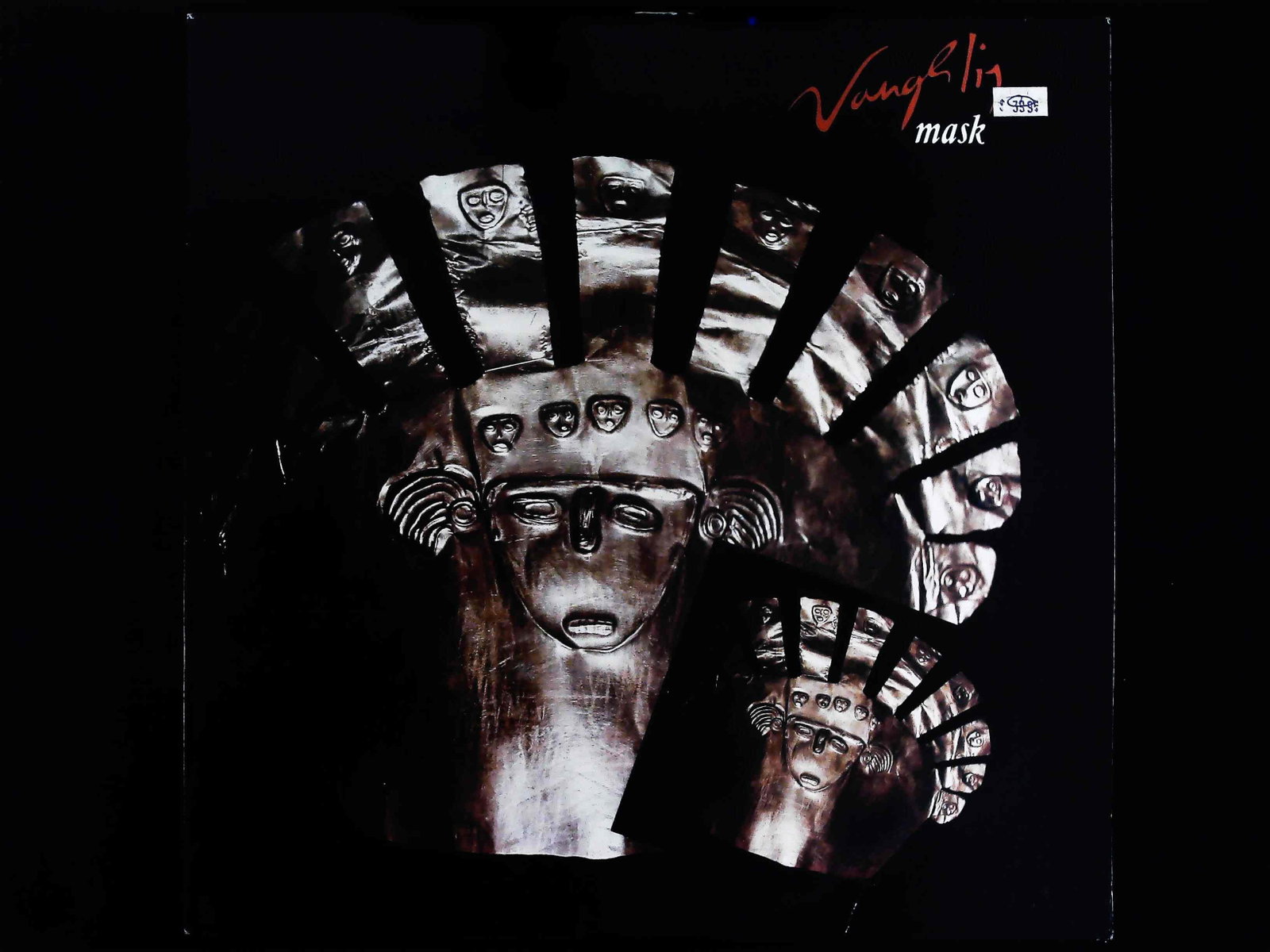 Vangelis Mask 1985 Polydor 12 Inch Vinyl LP Album: This lot consists of one (1) 12-inch vinyl LP record, Vangelis's 1985 album Mask, released on the Polydor label. The record is in its original album cover. The front cover features a dark image of