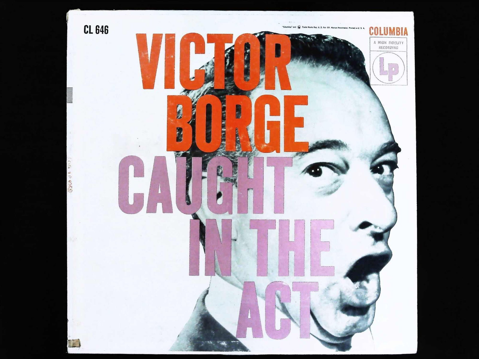 Victor Borge Caught in the Act Columbia Six Eye Vinyl LP: This is a single 12-inch vinyl LP record in its original album cover, featuring the comedian and pianist Victor Borge, titled Caught In The Act. The album was released on the Columbia label under