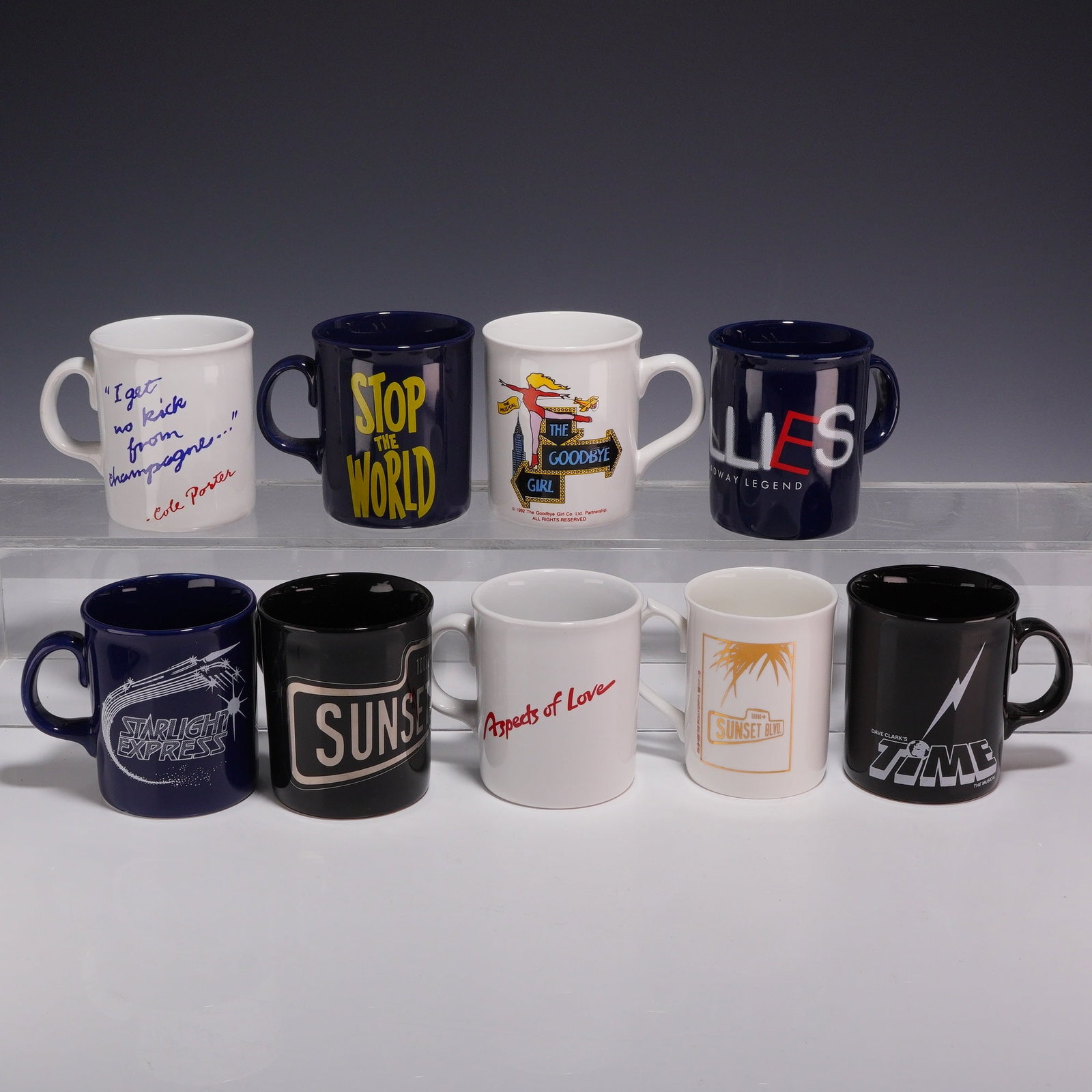 9pc Broadway and West End Musical Theater Souvenir Mugs Made in England: This collection consists of nine ceramic souvenir coffee mugs representing various Broadway and West End musical theater productions. Each mug features an embossed mark on the base reading MADE IN