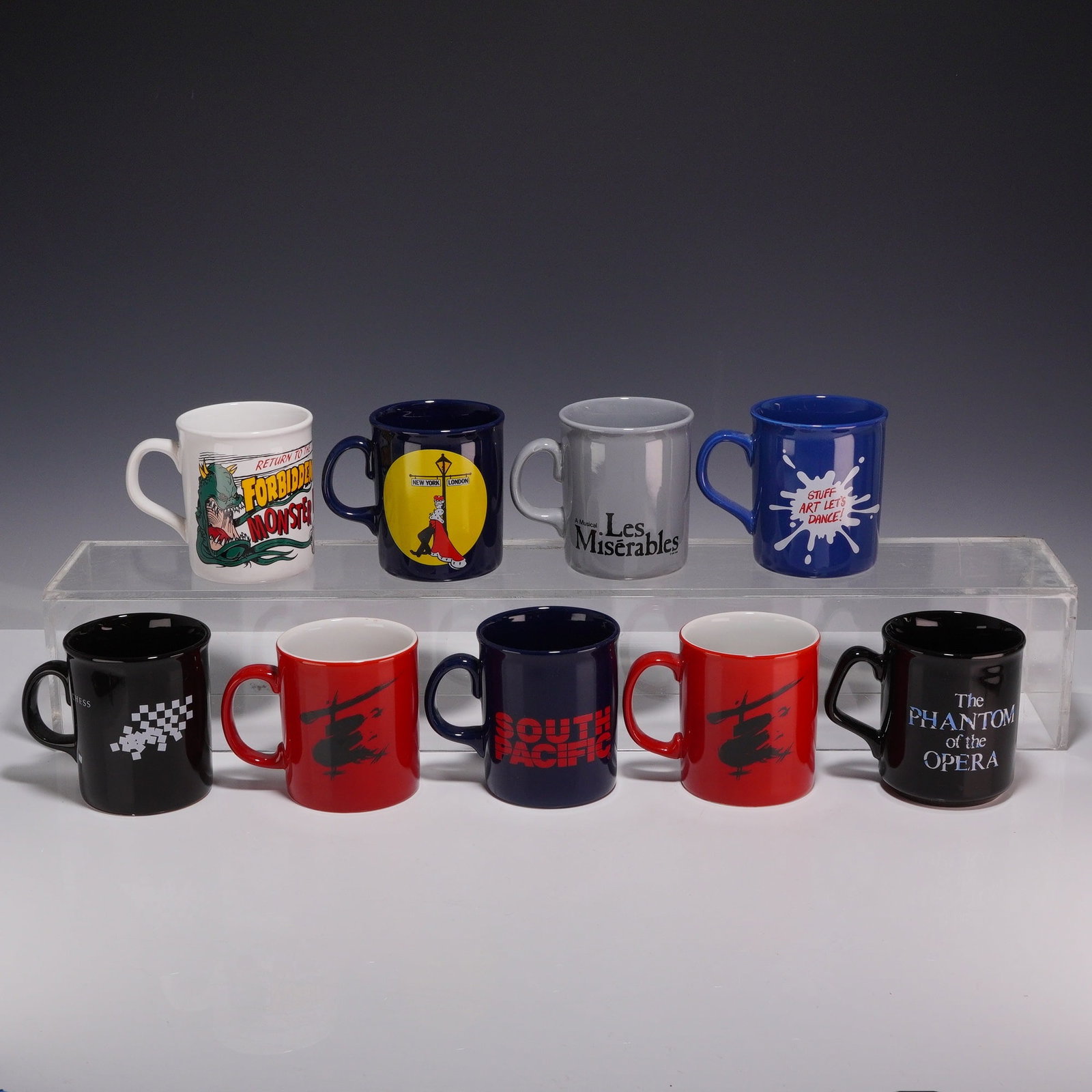 9pc Souvenir Ceramic Broadway Musical Theater Mugs Made in England: A collection of nine ceramic souvenir mugs representing various musical theater productions, primarily from the late 1980s and 1990s. The group includes items representing Les Miserables, The Phantom