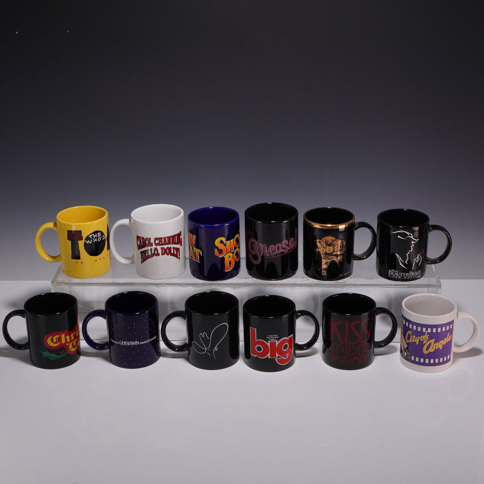 12pc Broadway Musical Souvenir Ceramic Mugs: A collection of twelve ceramic souvenir mugs representing various Broadway theatrical productions, primarily from the 1990s. The assortment features a mix of colors and graphic styles corresponding
