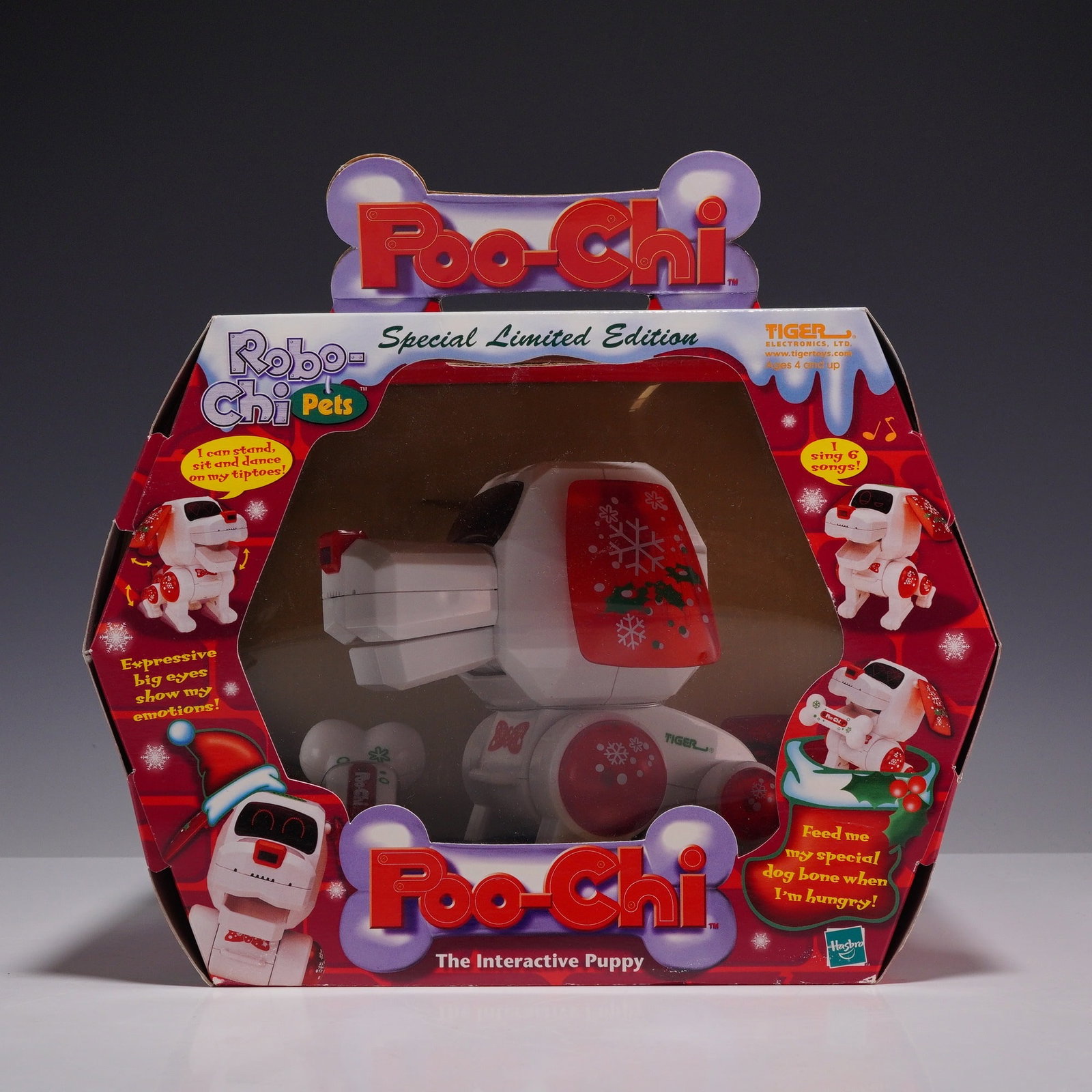 Tiger Electronics Poo-Chi Special Limited Edition Interactive Puppy in Original Box: This lot features a vintage Poo-Chi Robo-Chi Pets interactive robotic puppy, manufactured by Tiger Electronics, Ltd., a division of Hasbro. This unit is the Special Limited Edition holiday-themed mode