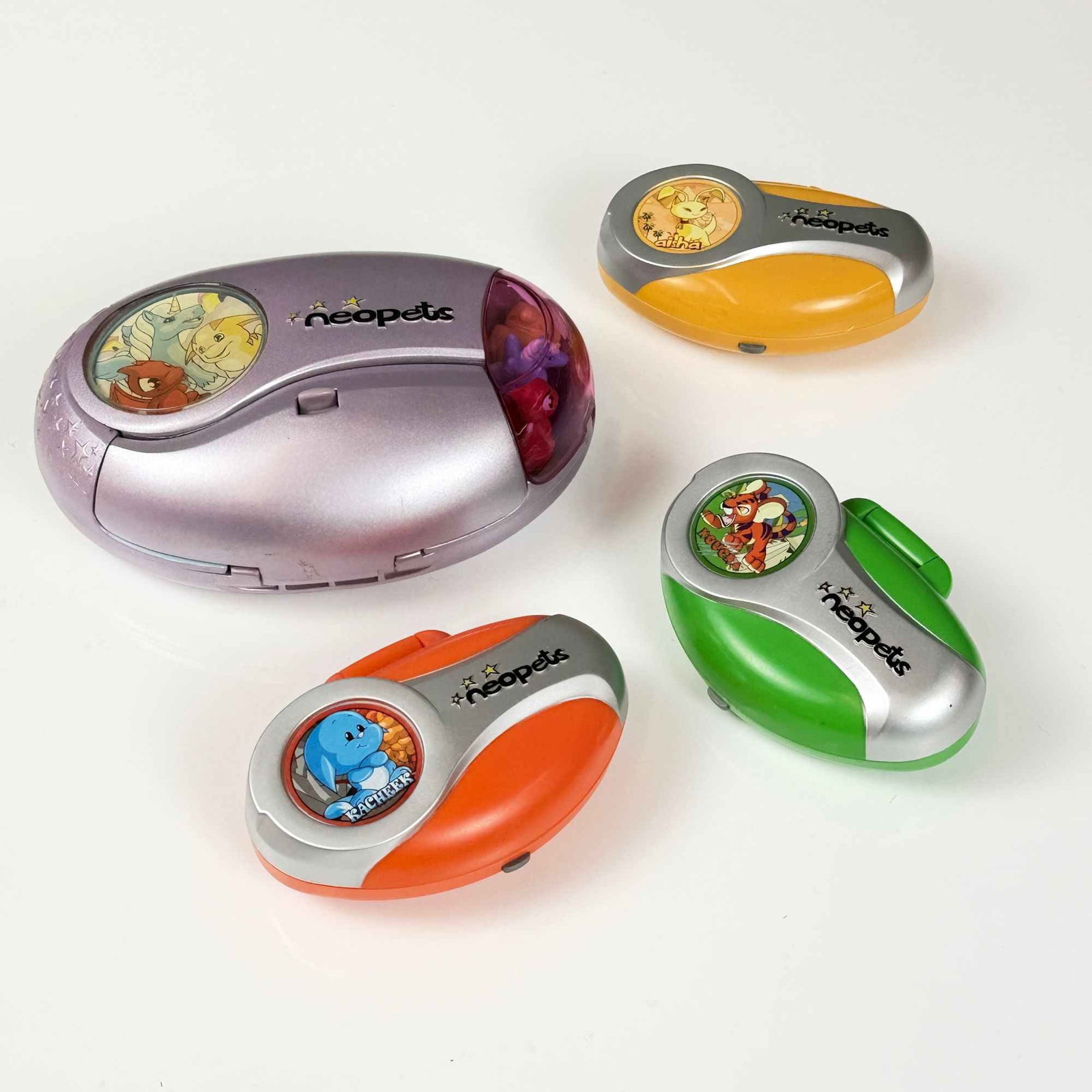 4pc Tiger Electronics Neopets Handheld Electronic Games and Playsets: This collection consists of 4 Neopets handheld electronic games and interactive pocket playsets manufactured by Tiger Electronics under license from Neopets, Inc. The set includes one Faerieland