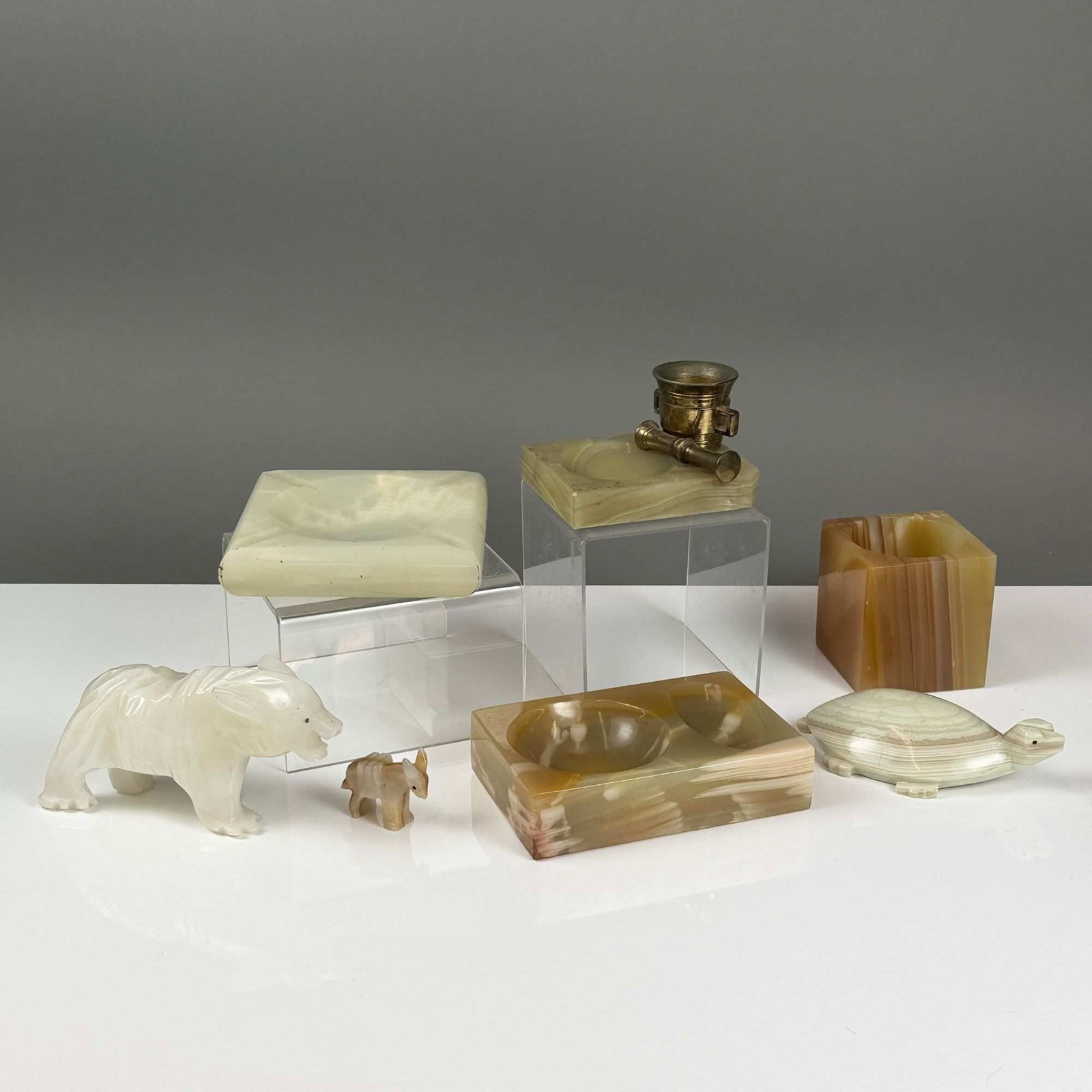 7pc Collection of Vintage Carved Onyx and Alabaster Desk Accessories and Animal Figurines: A collection of seven vintage carved stone desk accessories and animal figurines fashioned from banded onyx and alabaster in shades of cream, sage green, and amber brown. The group includes three