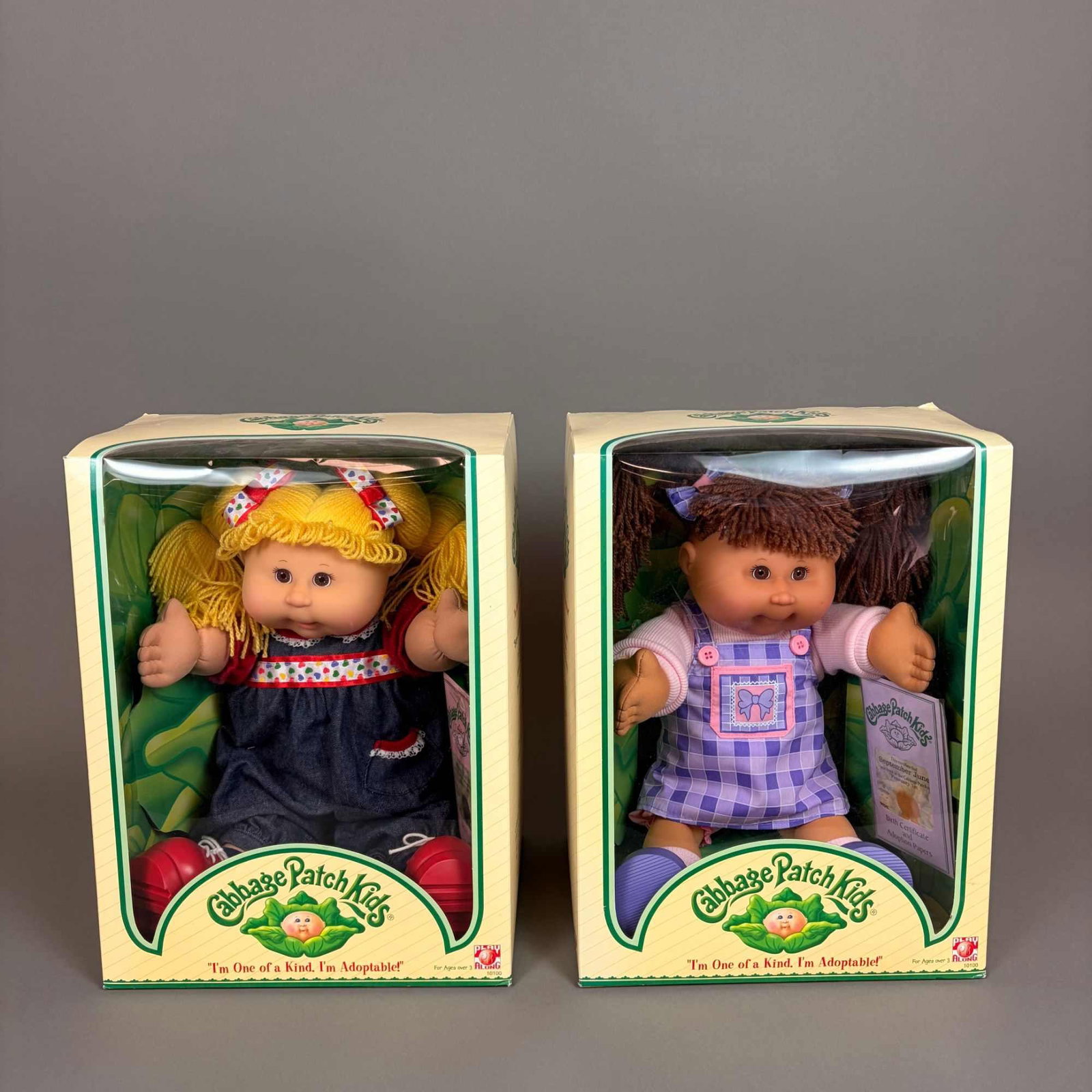 2pc Cabbage Patch Kids Dolls in Original Boxes: This pair of 2pc Cabbage Patch Kids dolls was manufactured by Play Along under license from Original Appalachian Artworks in 2004. Each doll features a vinyl head and hands with a soft cloth body and 