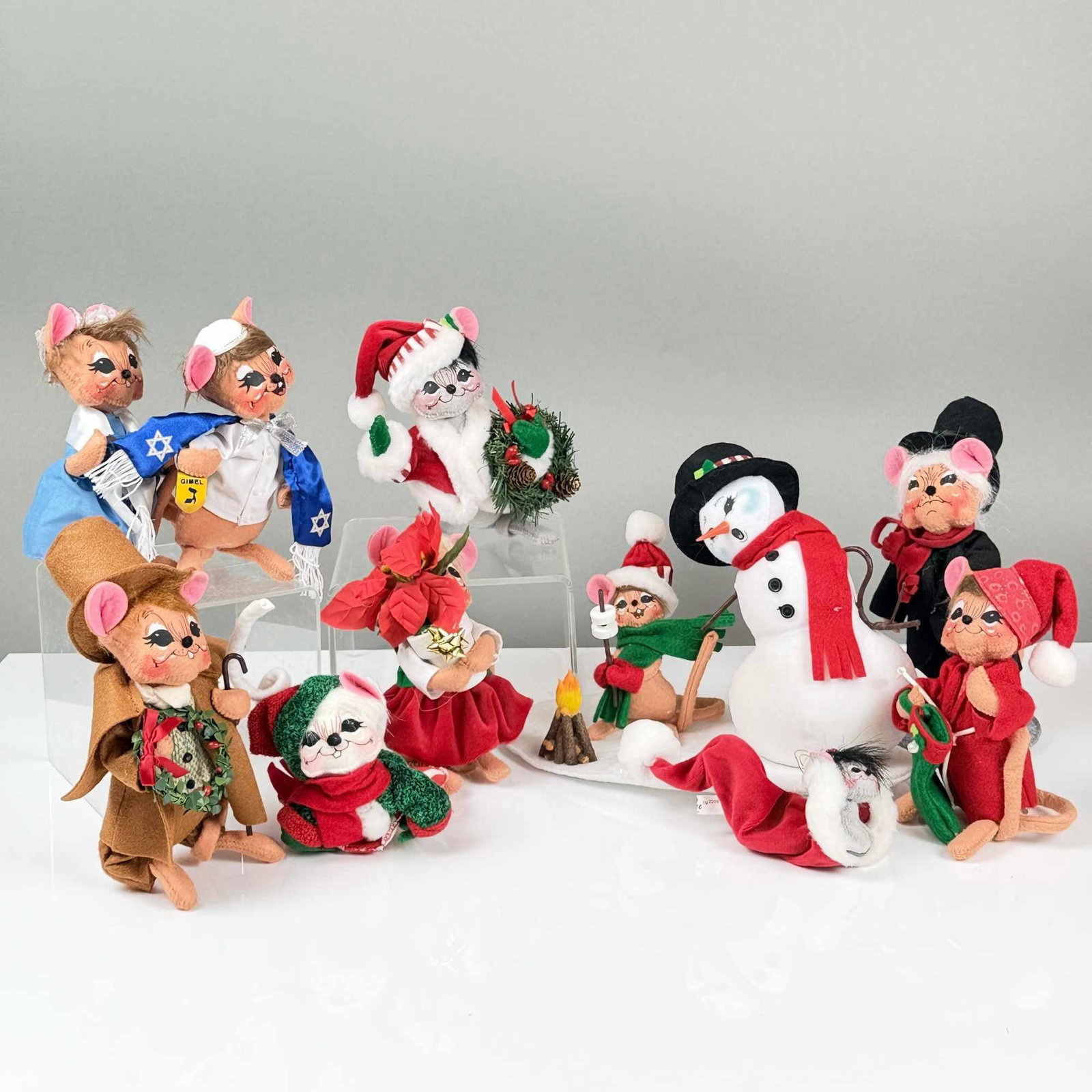 10pc Annalee Christmas and Hanukkah Figurines: This set of ten holiday-themed figurines is produced by Annalee and features a collection of Christmas and Hanukkah figurines depicting mouse characters and a snowman. The figures are constructed
