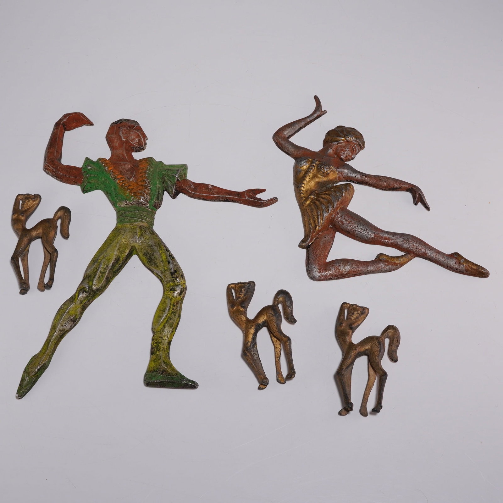 5pc Art Deco Style Cast Metal Wall Plaque Dancers and Mythical Creatures Figurines: This collection consists of five cast metal wall plaques designed in the Art Deco style, featuring two human figures and three stylized mythical creatures. The set includes a male figure in a lunging