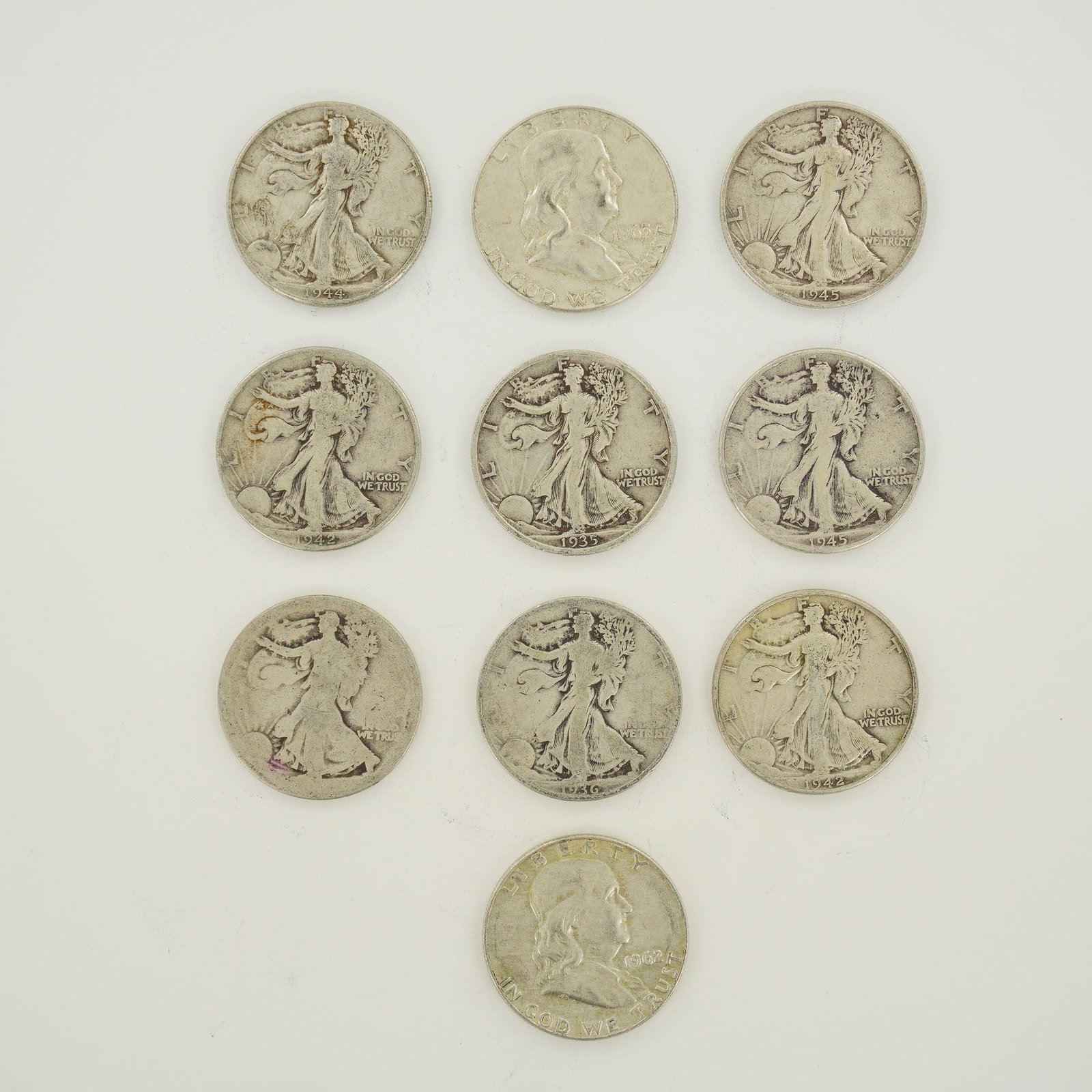 A Collection of US 90% Silver Half Dollars, Mixed Date Bag of Coins: A collection of US 90% silver half dollars including Walking Liberty and Franklin types. The assembly features a mixed date bag of coins with visible dates of 1935, 1936, 1942, 1944, 1945, 1962, and 1