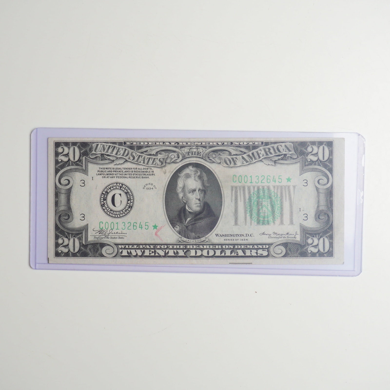 1934 US Twenty Dollars Green Seal Star Note: This lot features a Series 1934 $20 Federal Reserve Note issued by the Federal Reserve Bank of Philadelphia, often cataloged by collectors as a 1934 DC $20 bill. This specific specimen is a replacemen