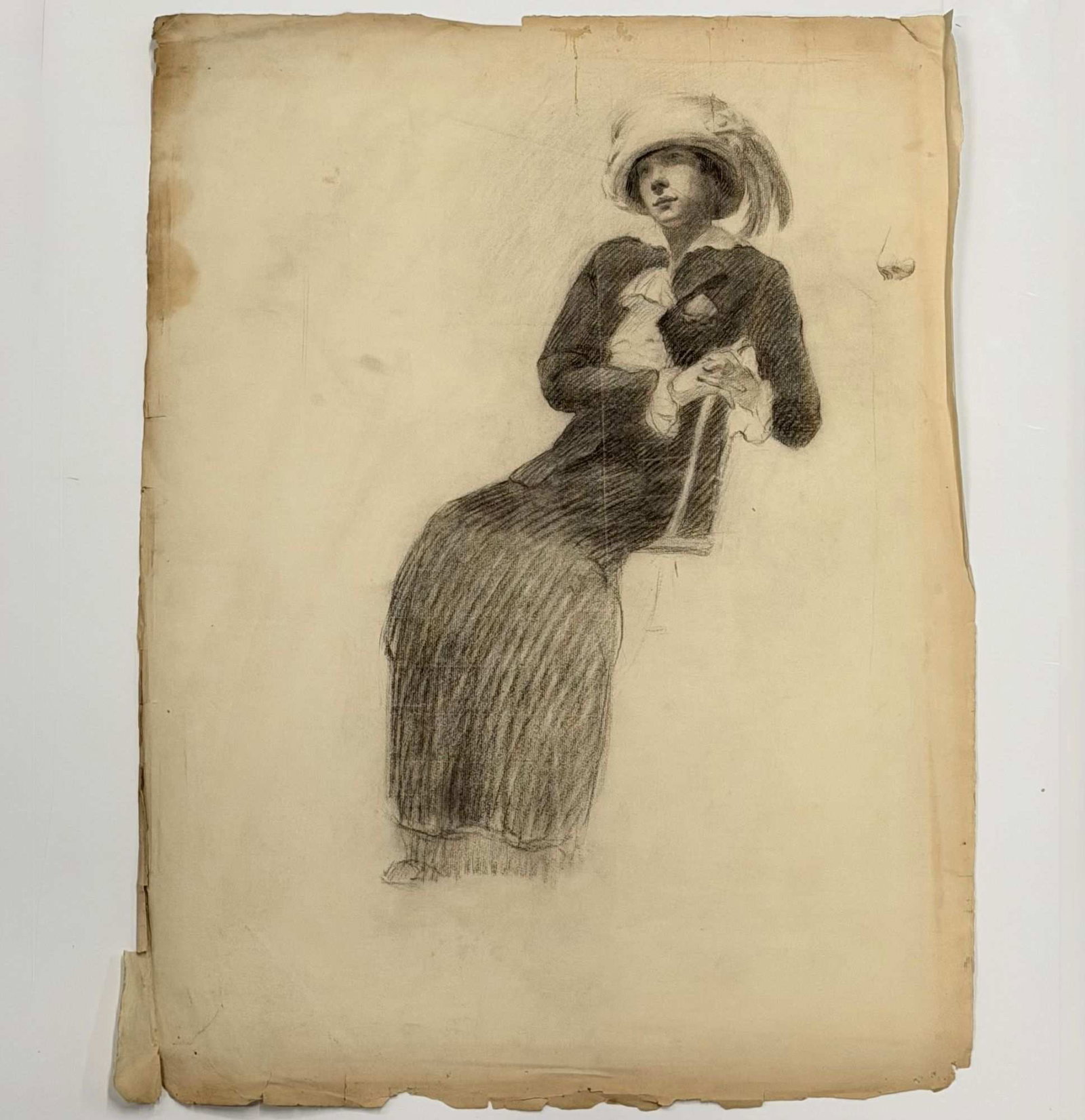 Angelo Comolli (Italian, 1863-1949), Seated Woman in Plumed Hat, Charcoal and Graphite Drawing, ca.: This original charcoal and graphite drawing on toned wove paper is by the Italian artist Angelo Comolli (1863-1949). According to historical provenance, this work was part of a portfolio created by th