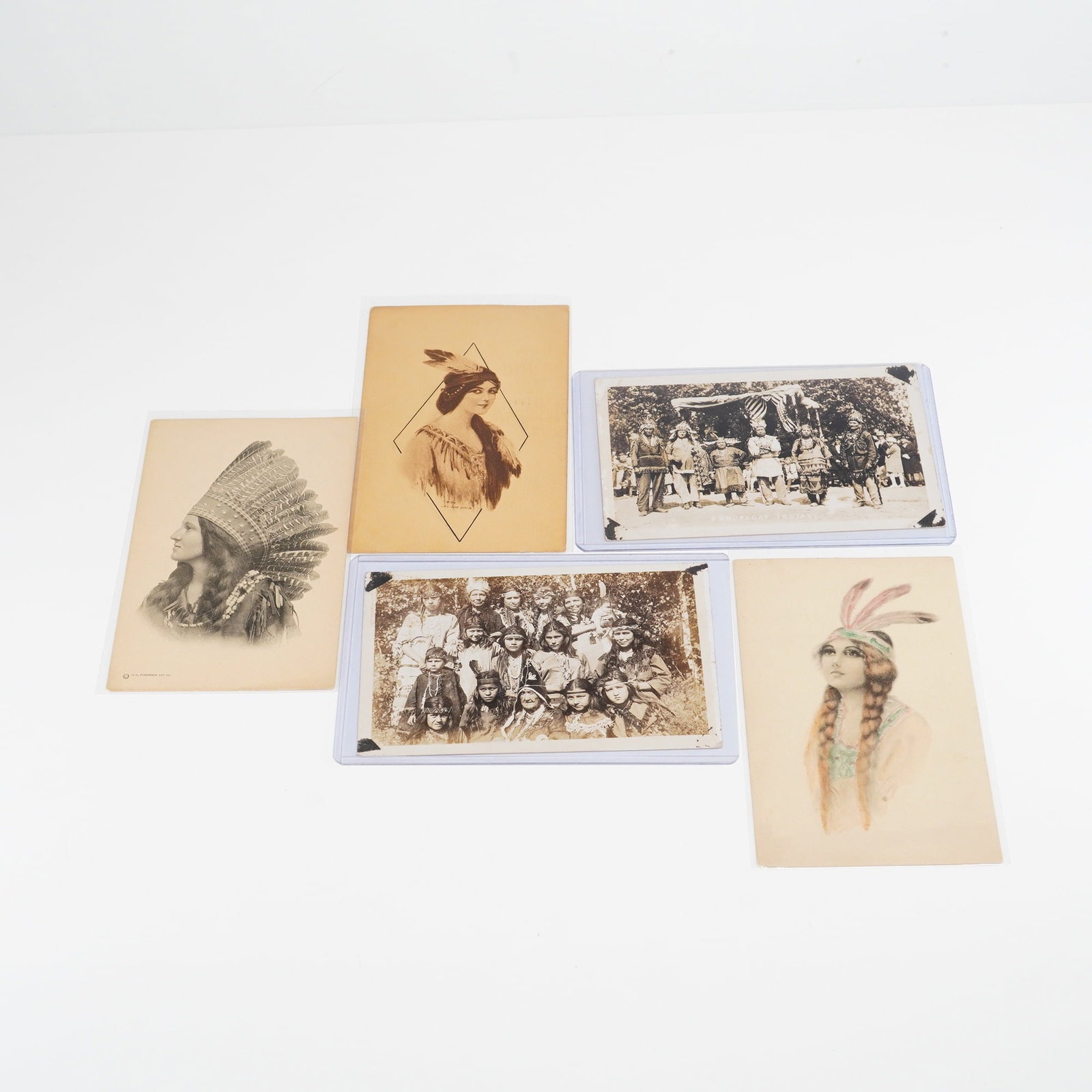 5pc Collection of Early 20th-Century Native American Themed Postcards: This lot consists of a 5pc collection of early 20th-century Native American cards, featuring a variety of artistic illustrations and photographic portraits. The group includes a vertical black and whi