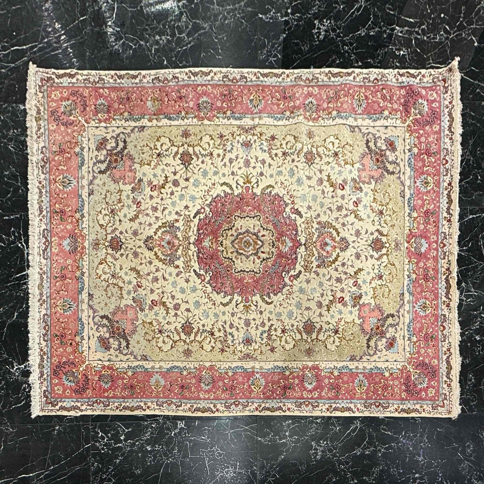 Large Hand-Knotted Silk Persian Rug with Pink and Blue Floral Accents and Fringe: This is a large, hand-knotted Persian silk rug, exhibiting the characteristic design and craftsmanship attributed to the Qum region of Iran. The rug features a central lobed floral medallion in rose a