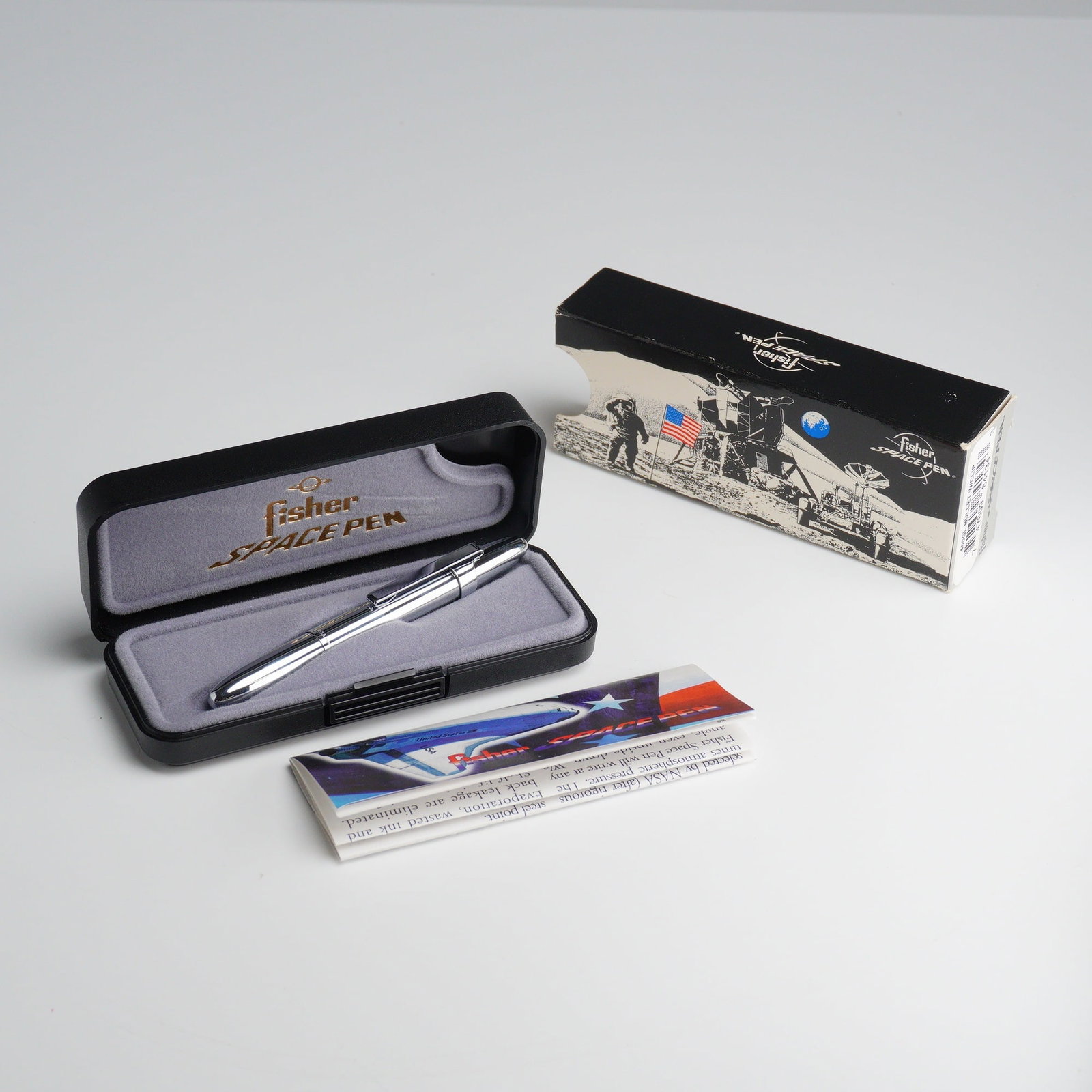Fisher 400CL Chrome Bullet Space Pen with Original Case: This lot features a Fisher Bullet Space Pen, model 400CL, constructed from chrome-plated brass. The pen utilizes a compact "bullet" design that measures approximately 3.75 inches when closed and exten