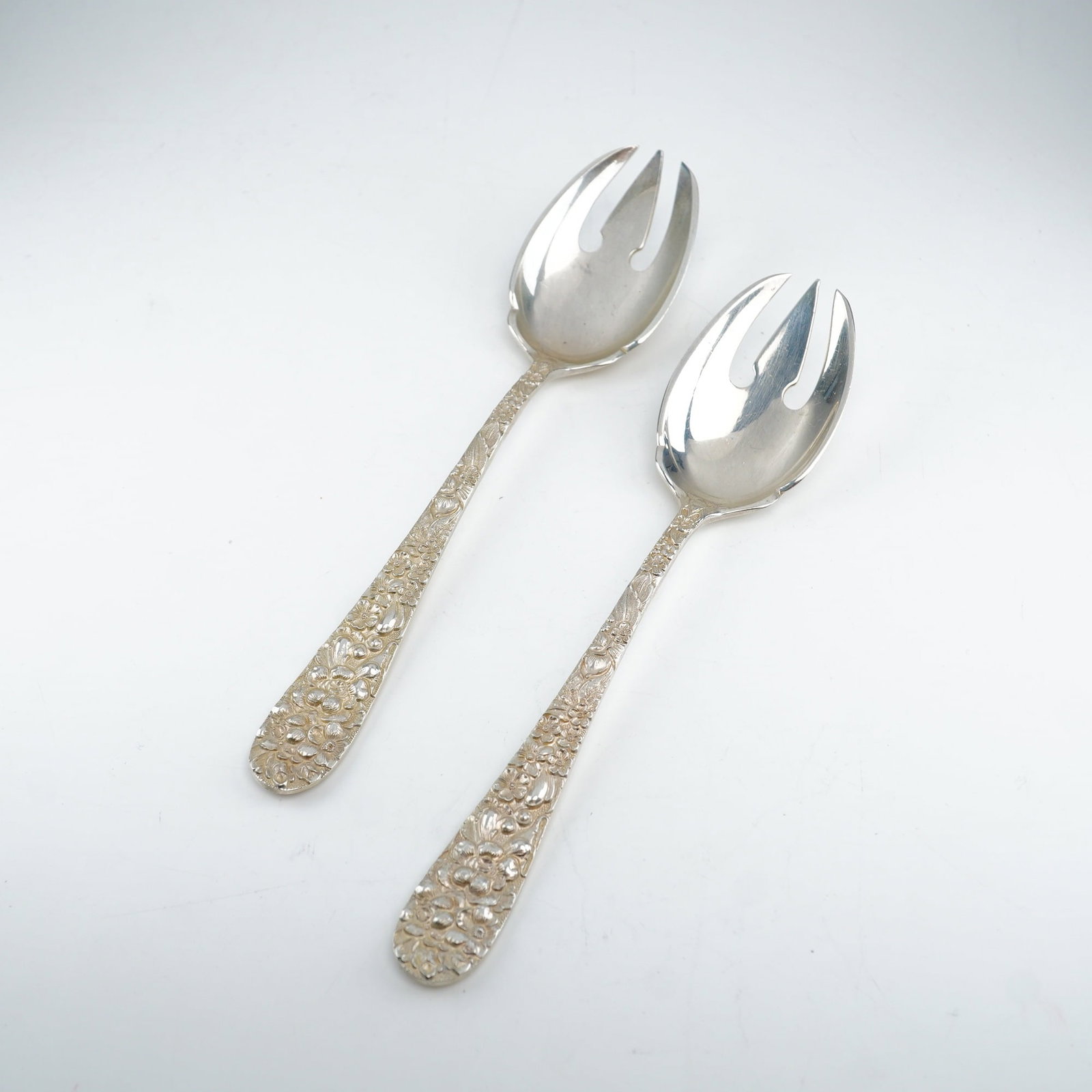 2pc Kirk Stieff Sterling Silver Ice Cream Forks, Stieff Rose: Each fork displays the iconic 1892 design featuring finely detailed floral repousse work on the handle, executed in the traditional raised-relief technique. Marked "Sterling Stieff." Dimensions: 6.00"