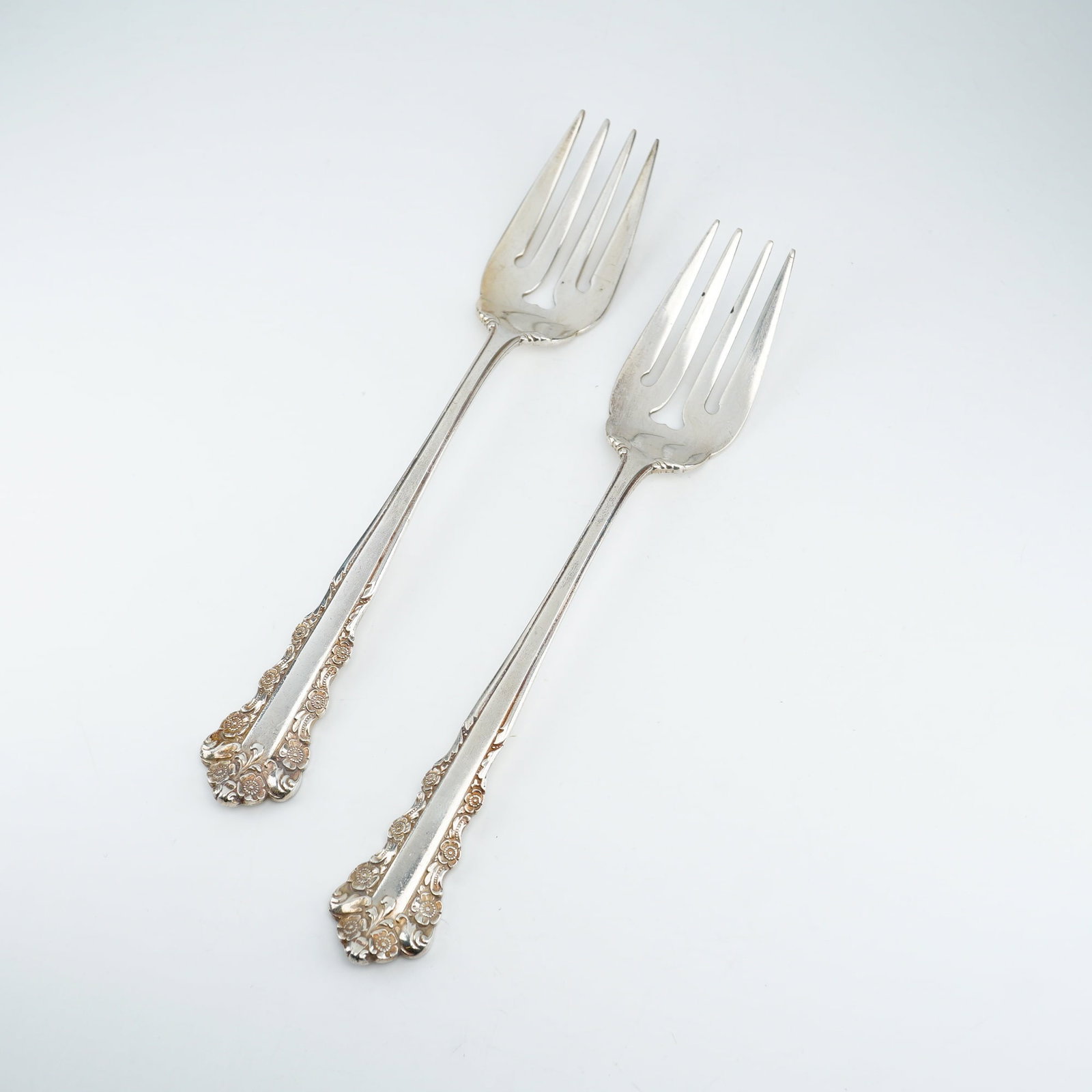 2pc Lunt Sterling Silver Salad Forks, Belle Meade: Two salad forks in the "Belle Meade" pattern by Lunt Silversmiths (1967??"1997). Each piece features ornate sterling silver construction with raised floral cluster relief and elegant Rococo-style scro