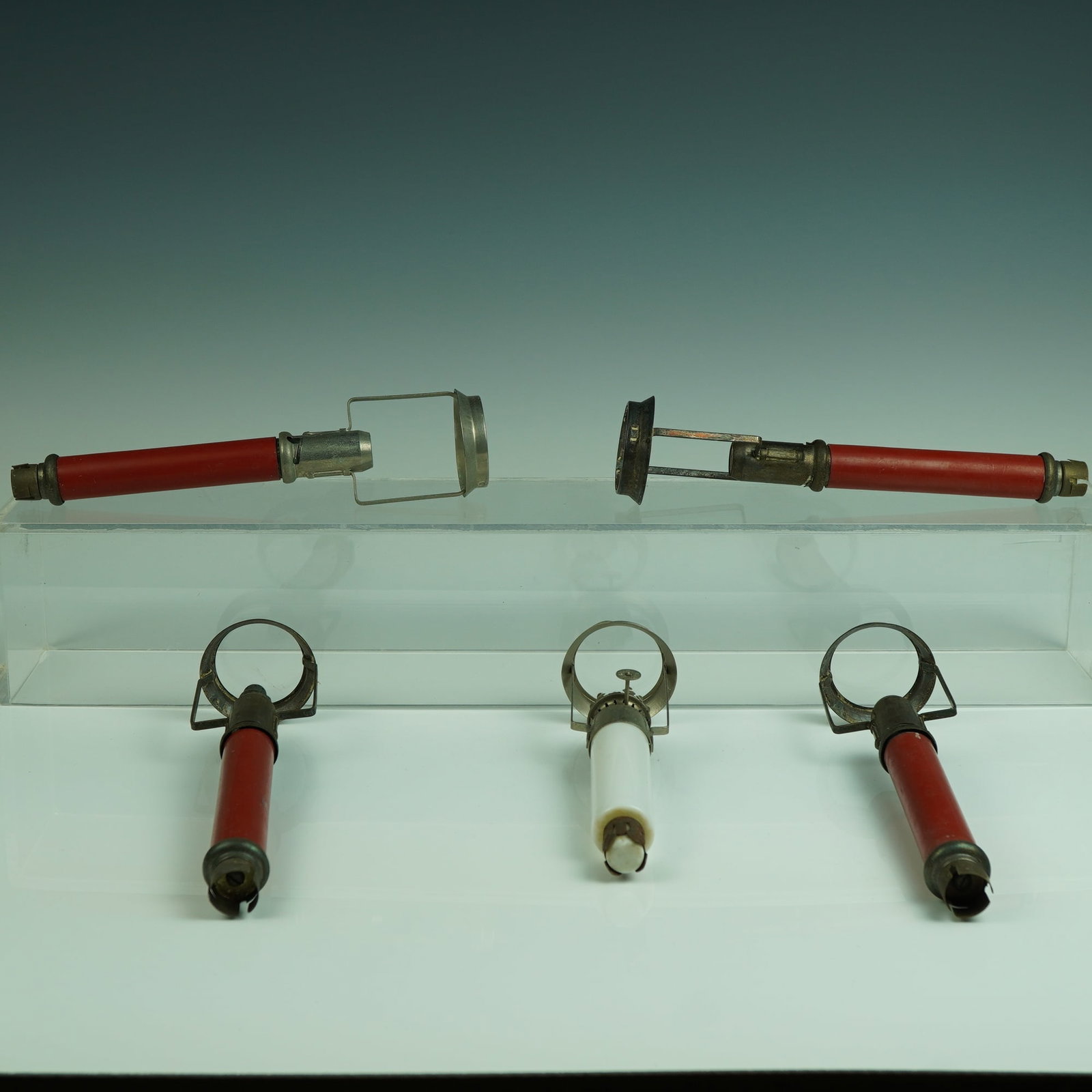 5pc Lighting Tools w/ 1 Twilight Candlestick Oil Lamp & 4 Igniters: A captivating 5-piece grouping of early 20th-century lighting tools and devices, highlighted by a scarce The Twilight candlestick oil lamp with a white opaline glass body and integrated burner