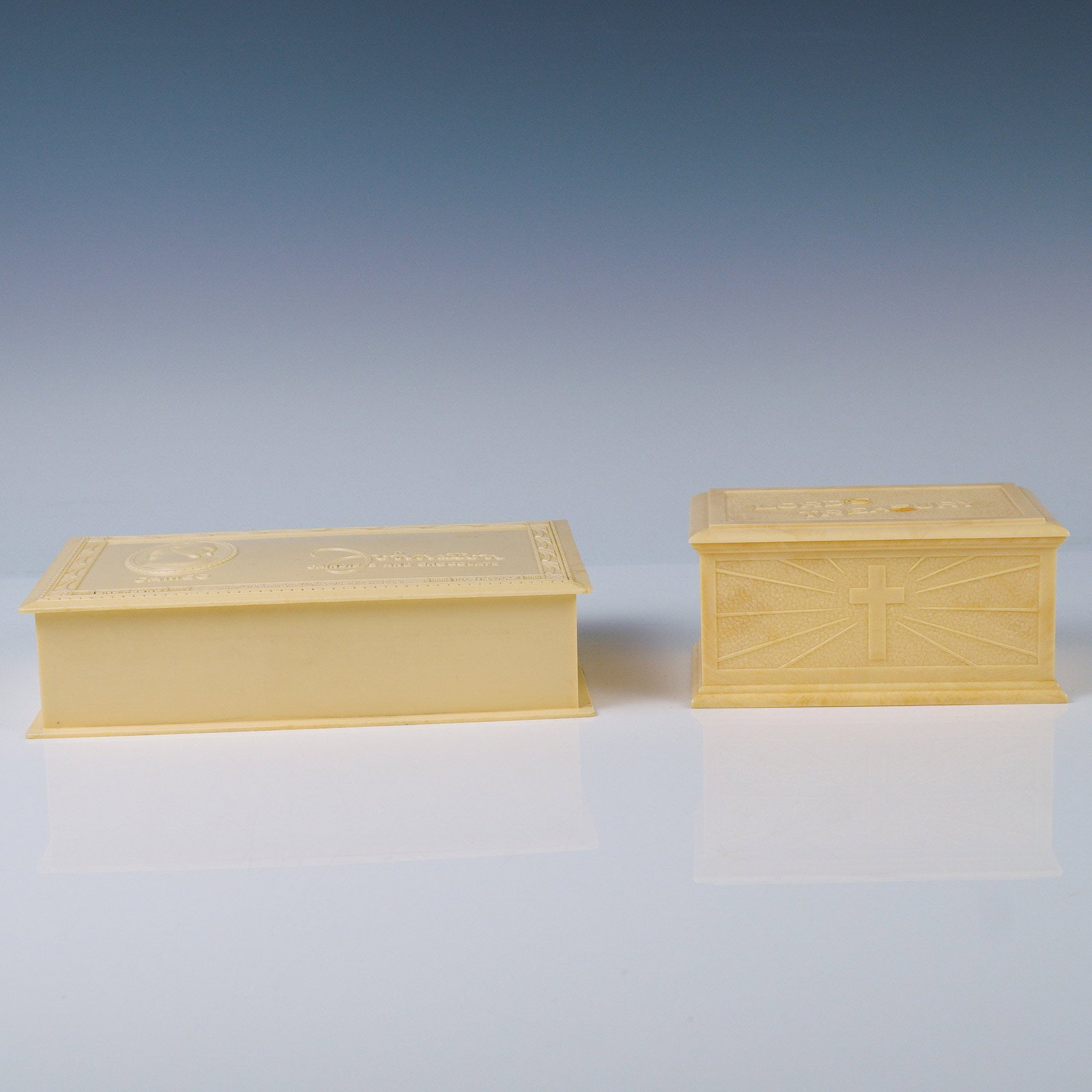 2pc Vintage Celluloid-Look Plastic Boxes: Offered here is a charming pair of mid-20th century molded plastic boxes in a pale ivory tone, both showcasing unique thematic and decorative appeal. The larger box is a vintage advertising premium