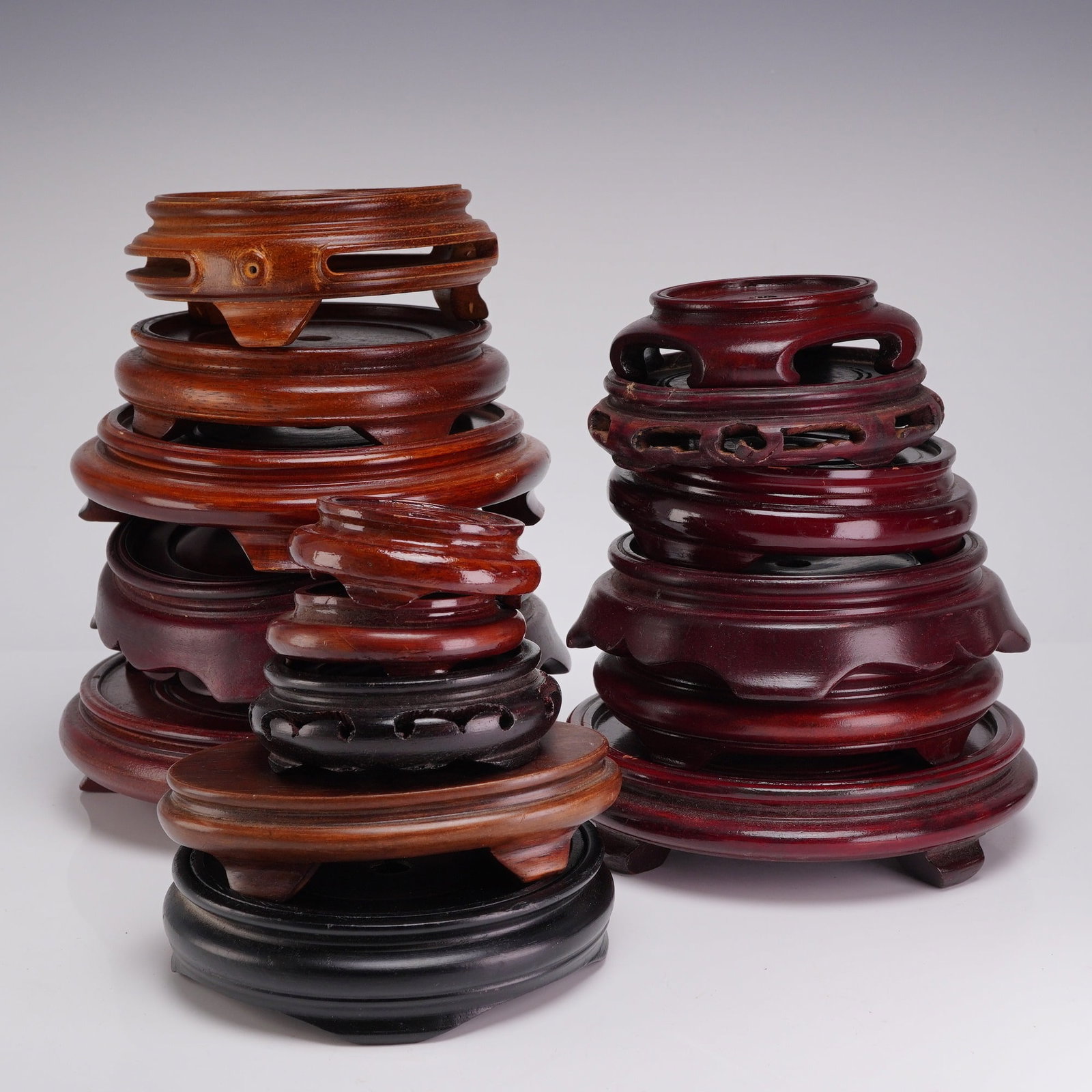 A Collection of 17 Wooden Chinese Display Bases: This collection consists of seventeen wooden Chinese bases designed for the display of porcelain, bonsai, and decorative works of art. The lot features an assortment of hardwoods finished with