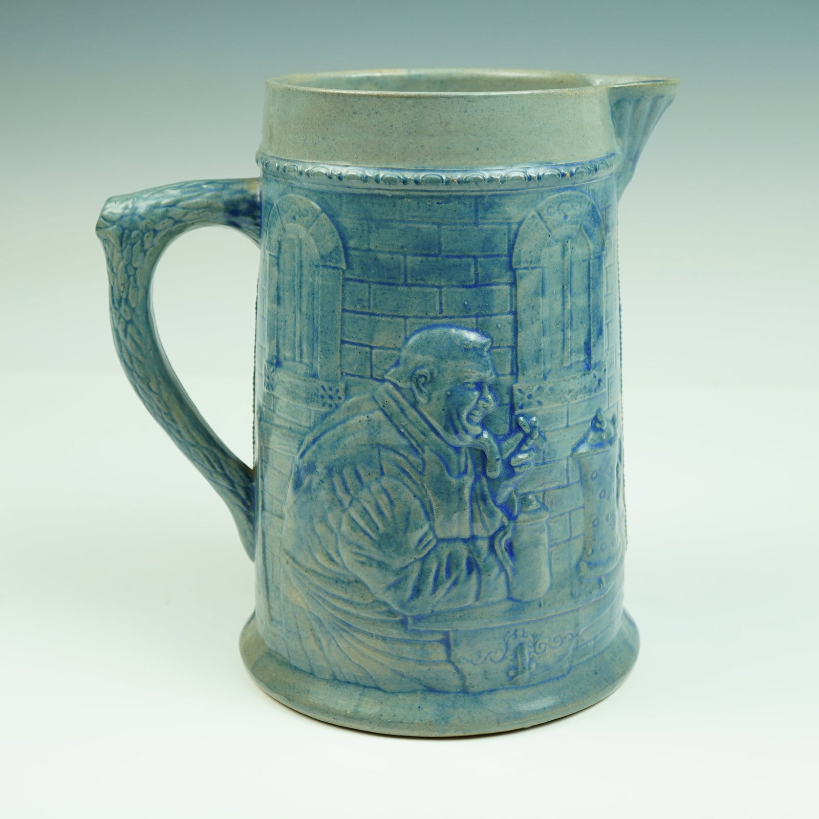 Belknap Hardware & Mfg. Co. Salt Glaze Stoneware Pitcher w/ Tavern Scene: Brimming with historic charm and turn-of-the-century Americana, this striking salt glaze stoneware pitcher was manufactured by the renowned Belknap Hardware & Mfg. Co. of Louisville, Kentucky, around 