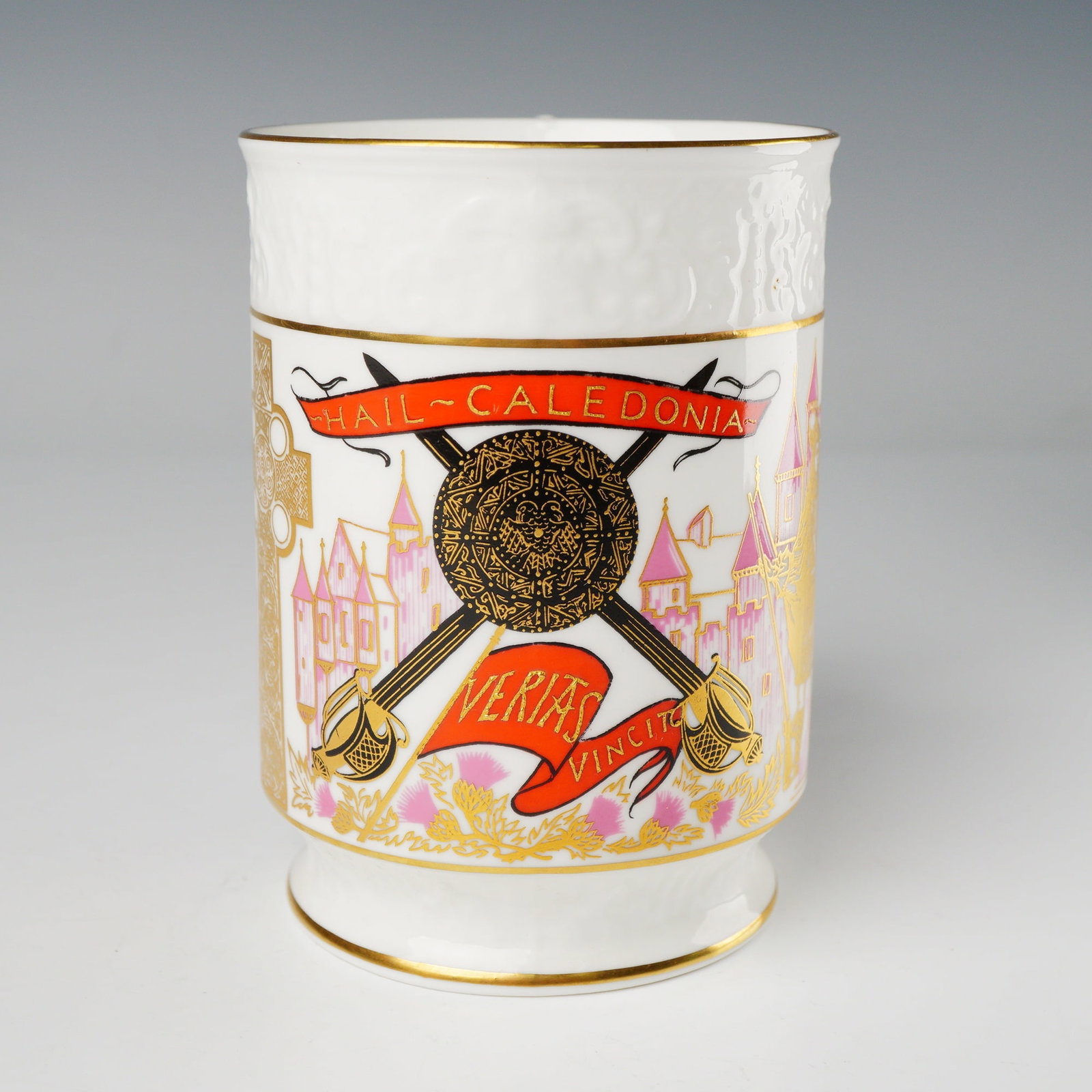Coalport Bone China Tankard, The Scottish Scene Hail Caledonia: A Coalport Bone China Mug, identified as The Scottish Scene by Coalport. This footed tankard features a cylindrical body and an elaborate, heavily gilt scroll handle. The upper rim includes a molded r