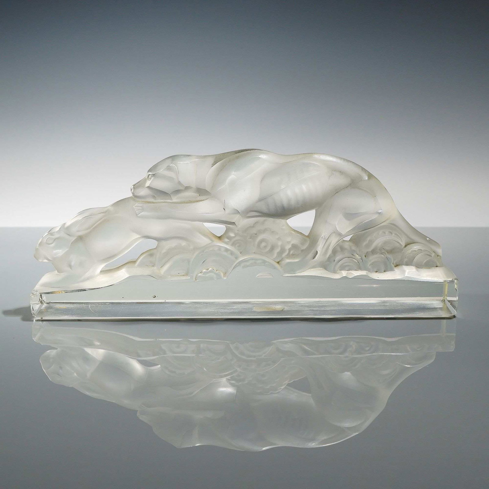 Heinrich Hoffmann Art Deco Frosted Glass Sculpture of a Dog Hunting a Rabbit: This Art Deco glass sculpture, designed by Heinrich Hoffmann, depicts a dog hunting a rabbit in a dynamic, stylized pursuit. The piece is crafted from a combination of clear and acid-etched frosted