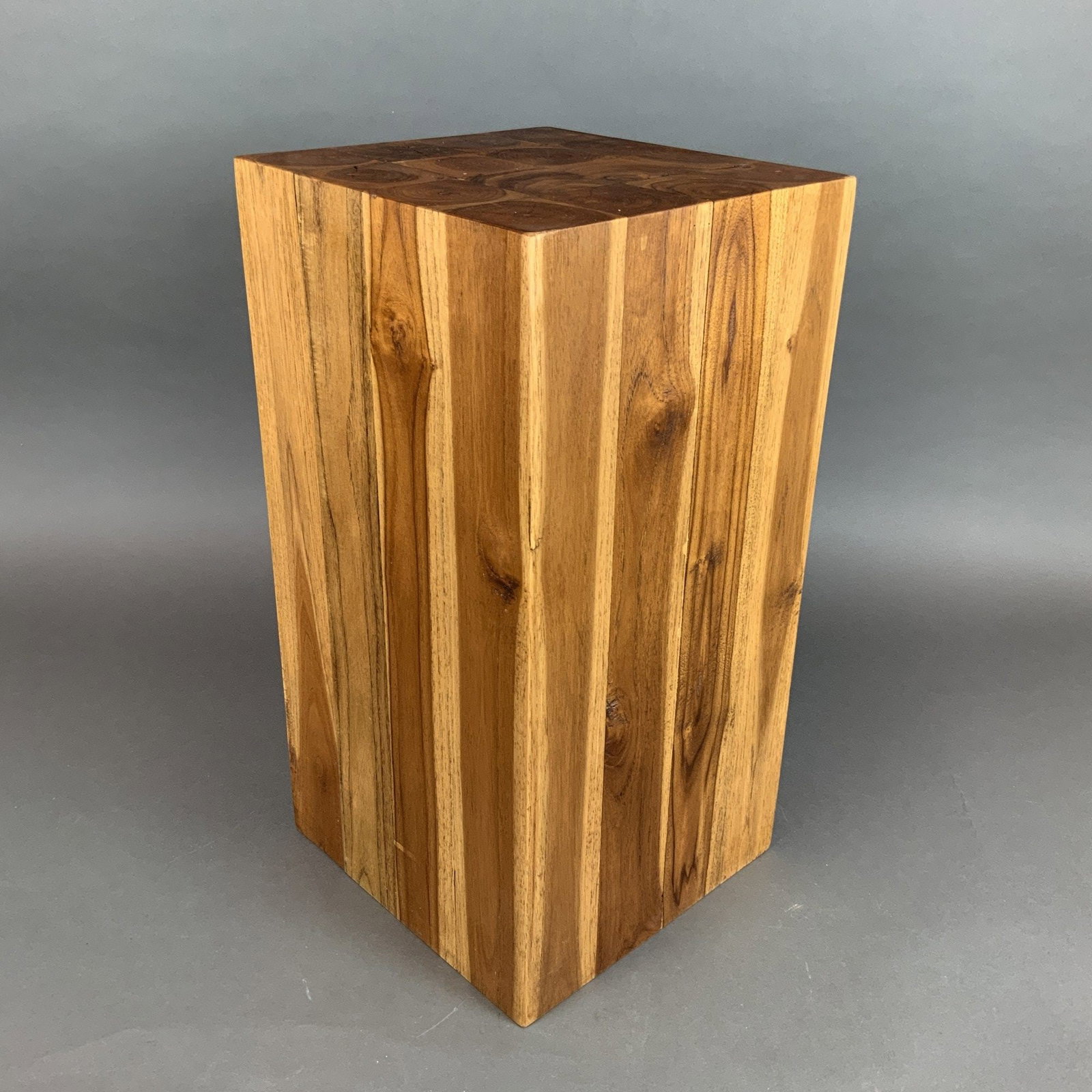 Modernist Multifaceted Solid Wood Block Table: A modernist block side table or pedestal of multifaceted geometric form. This piece is constructed from sixteen individual solid hardwood logs laminated together to create a dense, solid mass. The top