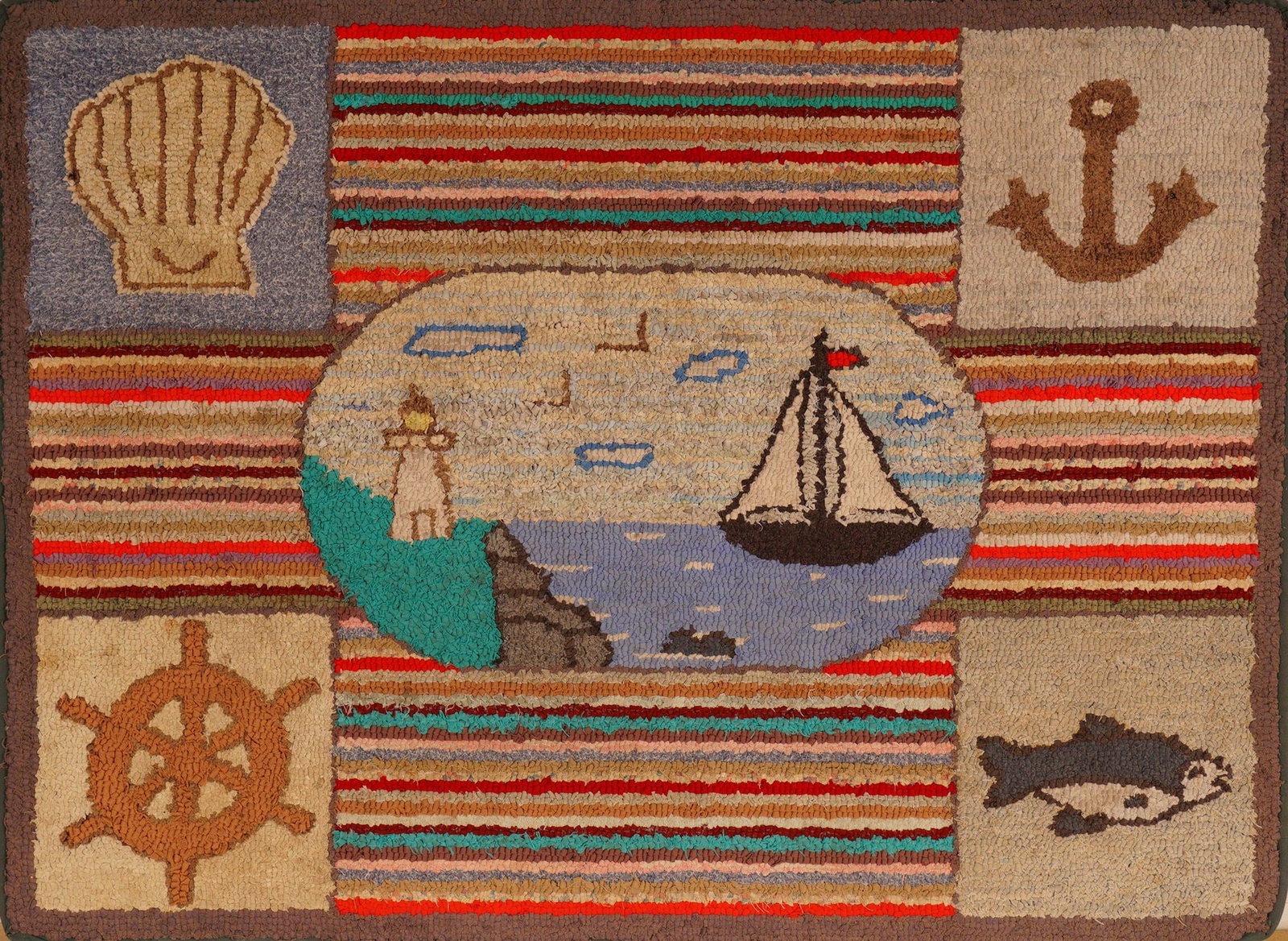 Mid-Century Old Maine Framed Hand-Hooked Rug, Nautical Folk Art Scene: Delightful hand-hooked wool rug depicting a classic coastal Maine theme. The central medallion features a sailboat gliding past a lighthouse under a soft blue sky with seagulls, surrounded by bold hor