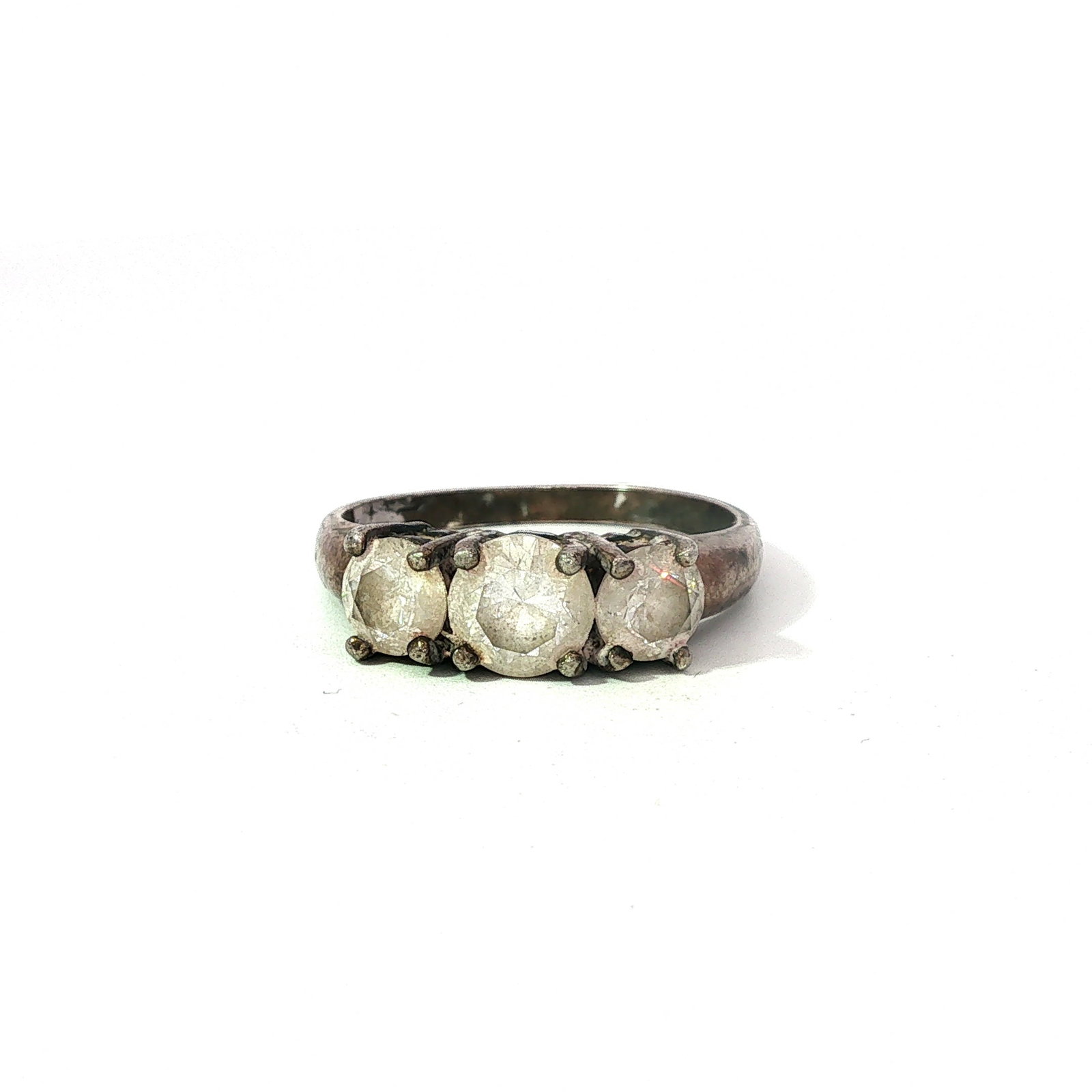 Sterling Silver Trilogy 3 Stone Ring: A sterling silver ring featuring three round-cut clear gemstones. No visible stamp. Thermo Scientific Niton XL2 XRF Precious Metal Analyzer tested. Dimensions: 1.00"L x 0.75"W Weight: 3.20g