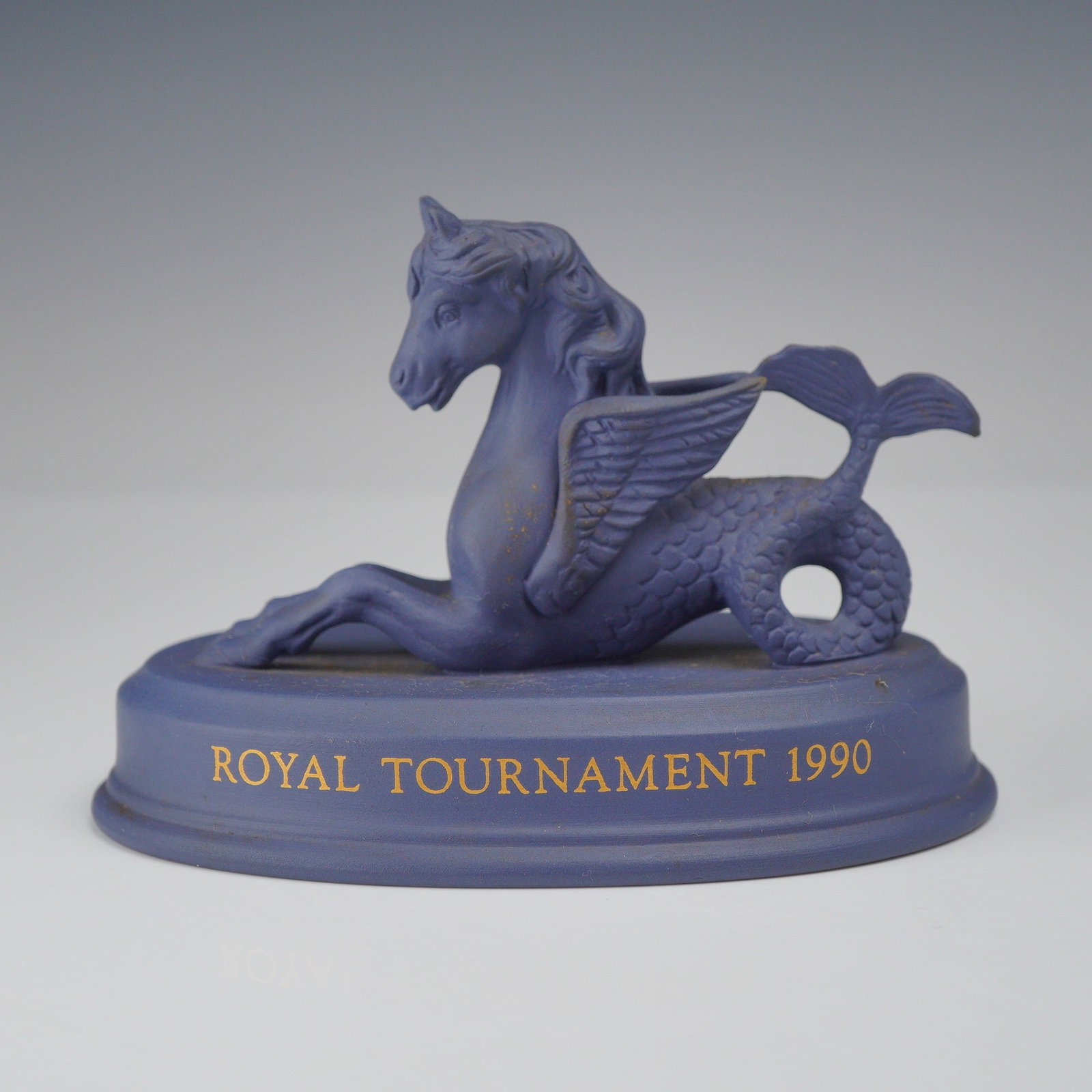 Wedgwood Portland Blue Jasperware Royal Tournament 1990 Hippocampus Figurine: A Wedgwood Portland blue jasperware commemorative figurine of a winged hippocampus, produced for the 1990 Royal Tournament. The mythical creature is depicted with a horse head and forelegs, feathered 