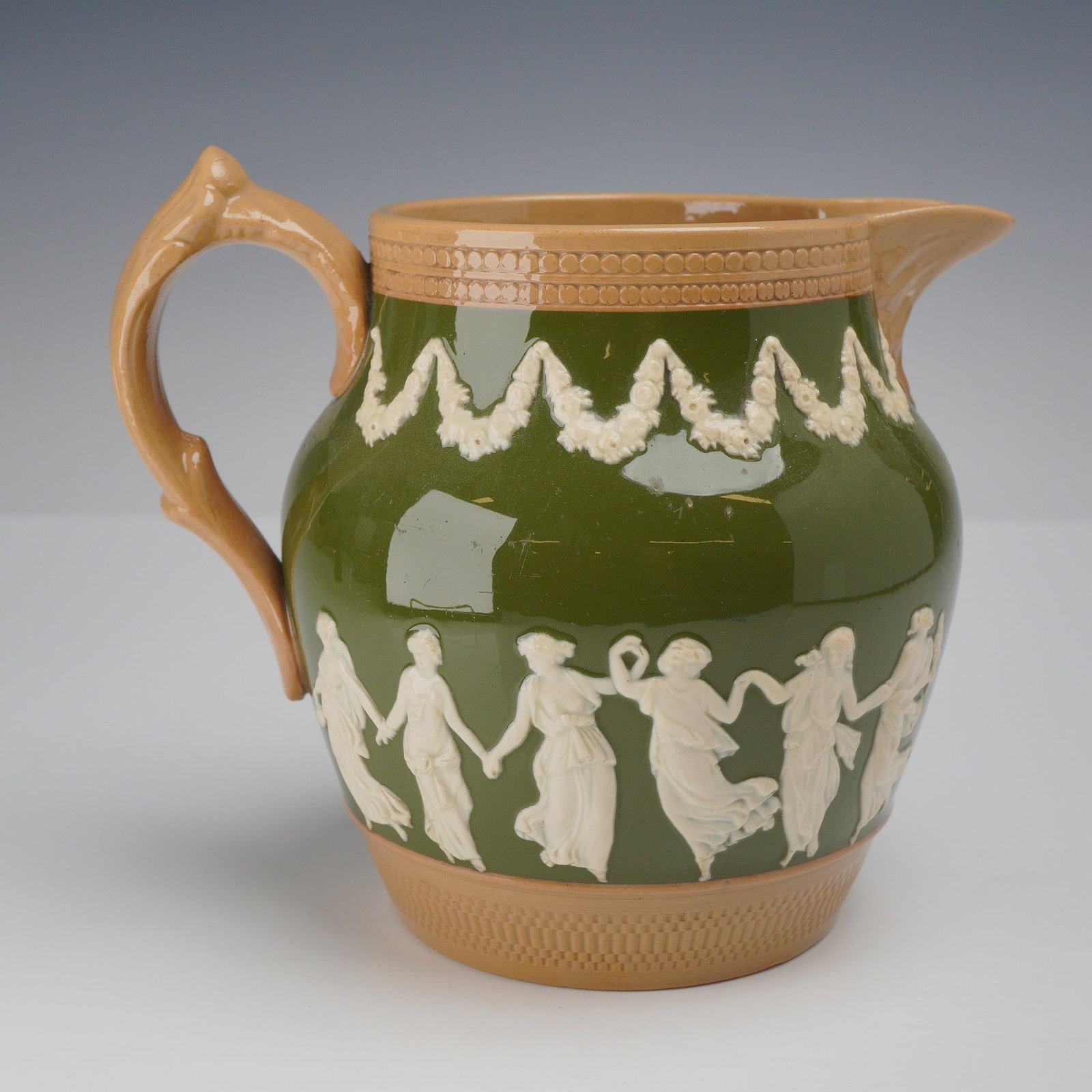 Copeland Late Spode England Earthenware Green Glazed Pitcher: A green-glazed earthenware pitcher from the Rubin Collection, manufactured by Copeland Late Spode. The vessel features a bulbous body finished in a deep green glaze, adorned with white sprigged relief