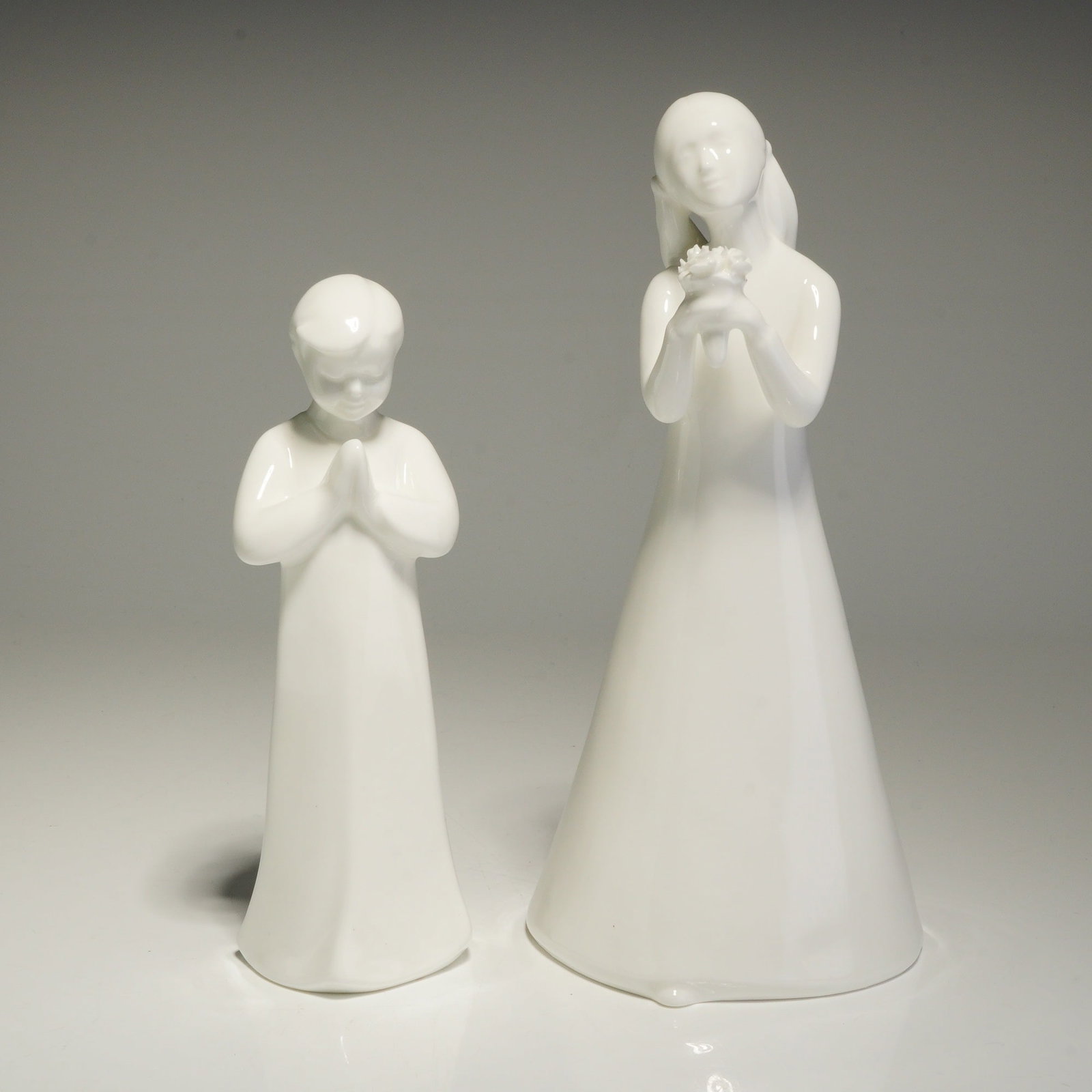 2pc Royal Doulton Images Figurines, Happy Birthday HN3829 and Prayer HN4378: Two Royal Doulton bone china figurines from the Images series, featuring a minimalist, stylized design with a smooth, glossy white glaze. The figurine titled Happy Birthday HN3829 was modeled by Dougl