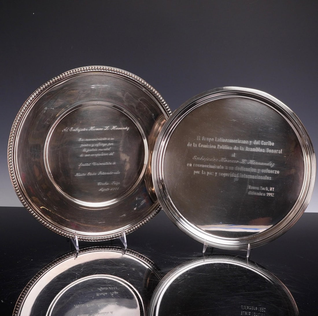 Two Lunt Silversmiths and Touzeau Silver-Plated Presentation Platters: A pair of silver-plated presentation platters or salvers awarded to Ambassador Homero L. Hernandez. The first platter features a stepped rim design and is produced by Lunt Silversmiths as part of a
