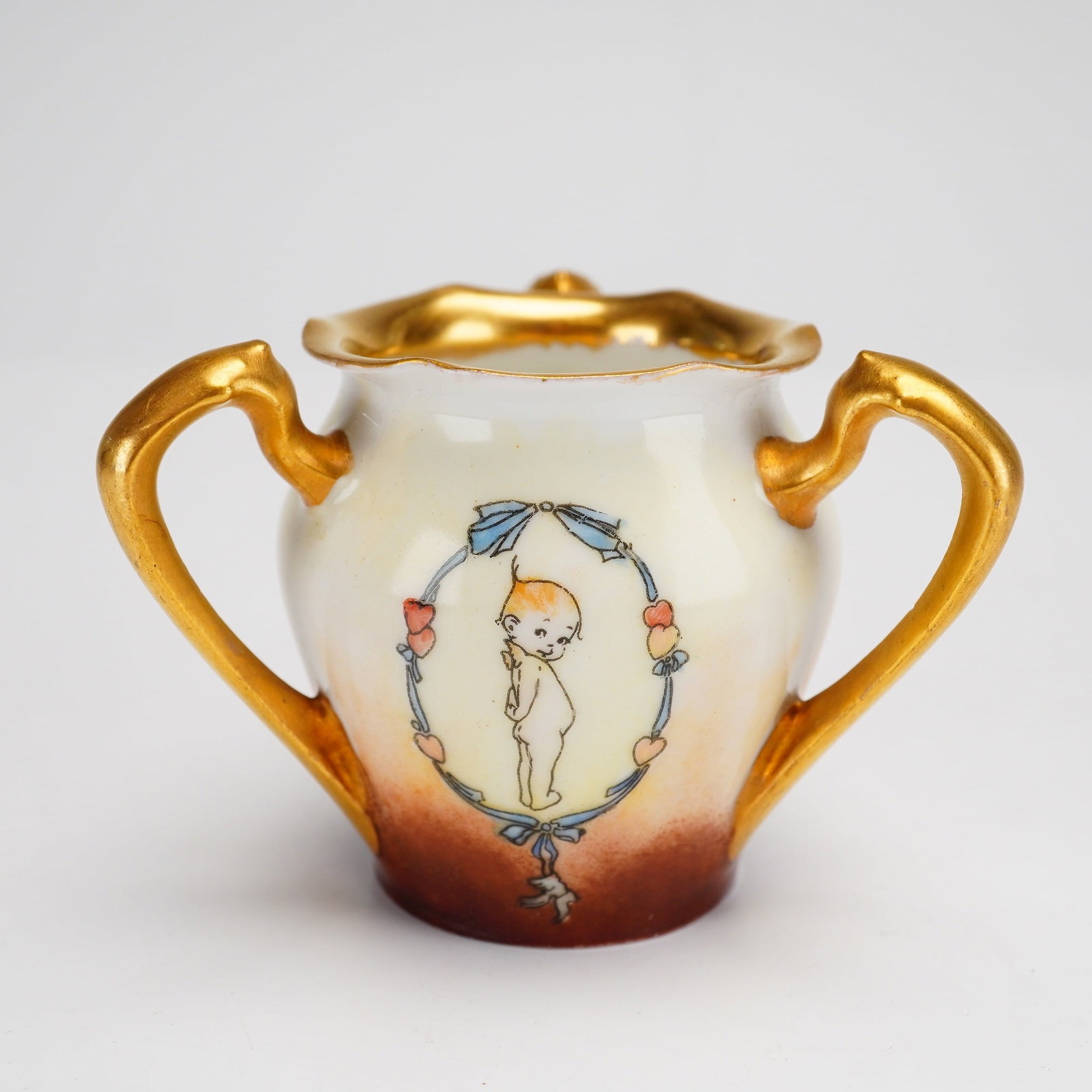 R.S. Germany Porcelain Tri-Handled Bon-Bon Dish: A Reinhold Schlegelmilch (R.S. Germany) fine porcelain vessel, functioning as a tri-handled bon-bon dish or basket. The piece features an ovoid form with a fluted, scalloped rim and two ornate, scroll