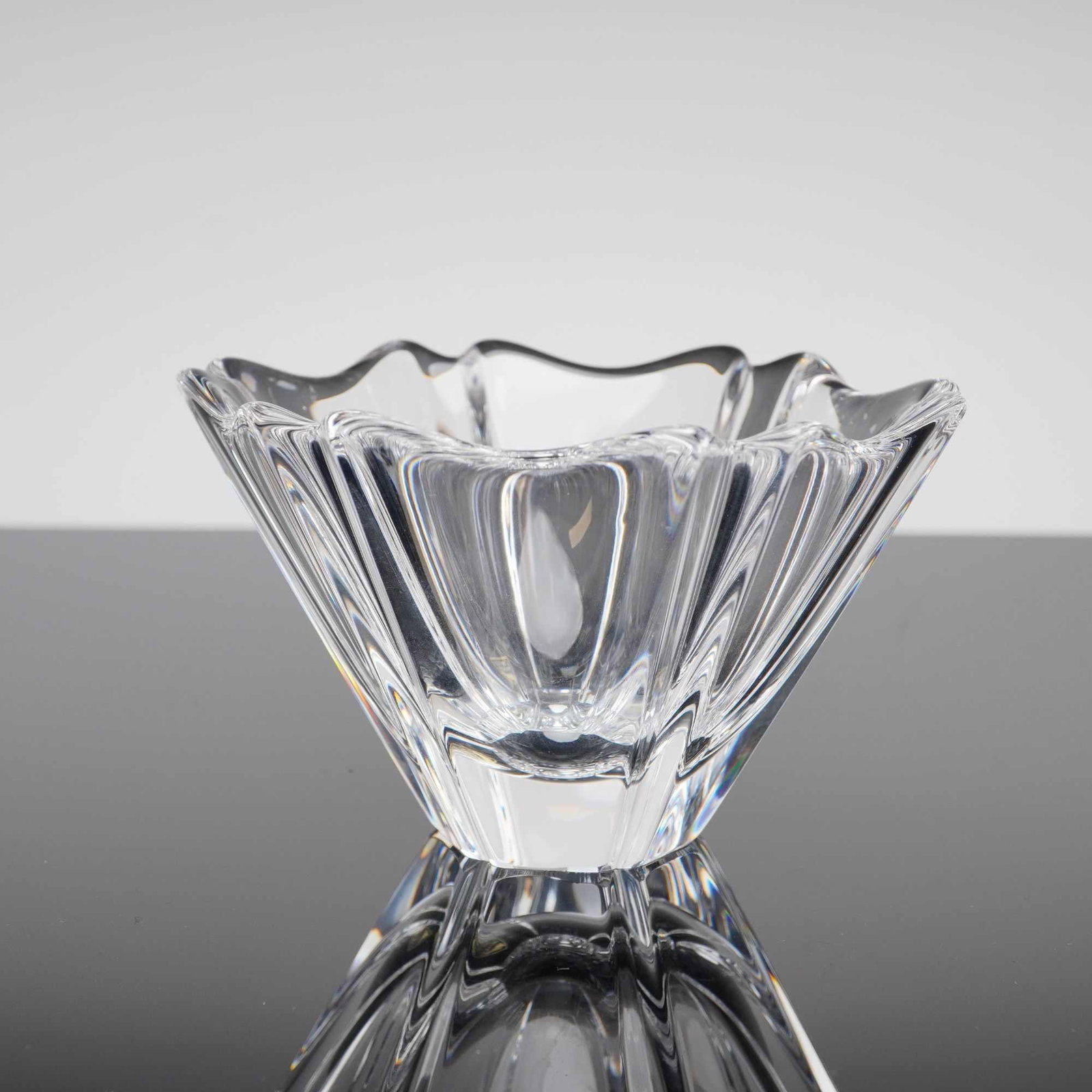 Orrefors Crystal Bowl, Orion: A fine Orrefors Orion round bowl crafted in heavy Swedish lead crystal. Designed by the acclaimed artist Lars Hellsten, this piece features a signature tapered form with deep, polished vertical flutin