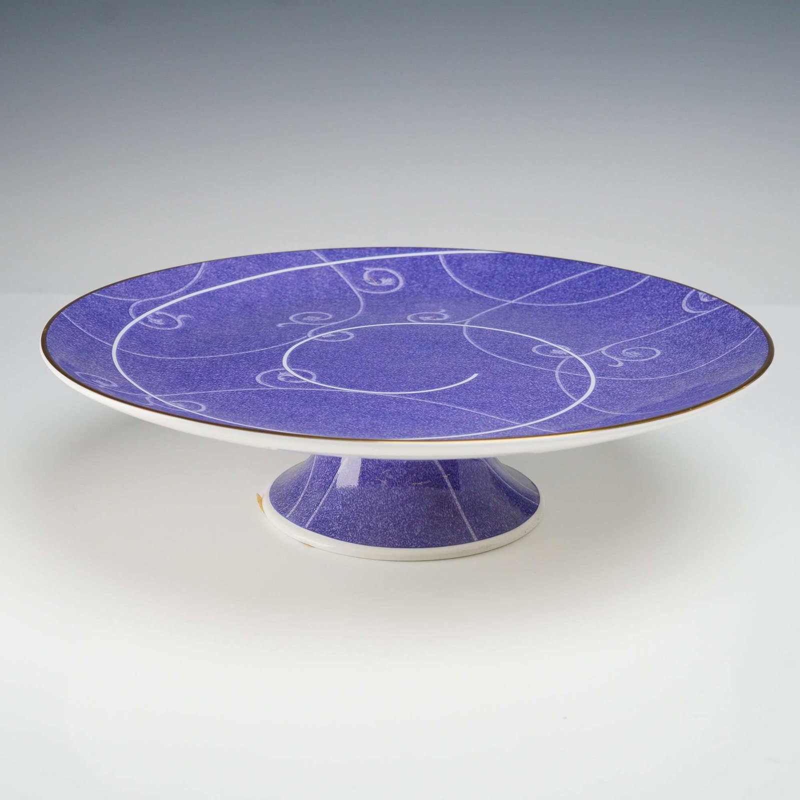Wedgwood Millennium Time for Wedgwood Bone China Stamped Footed Compote: A Wedgwood bone china footed compote plater from the Millennium collection. This stamped piece features the Time for Wedgwood pattern, characterized by a mottled violet-blue ground decorated with a wh