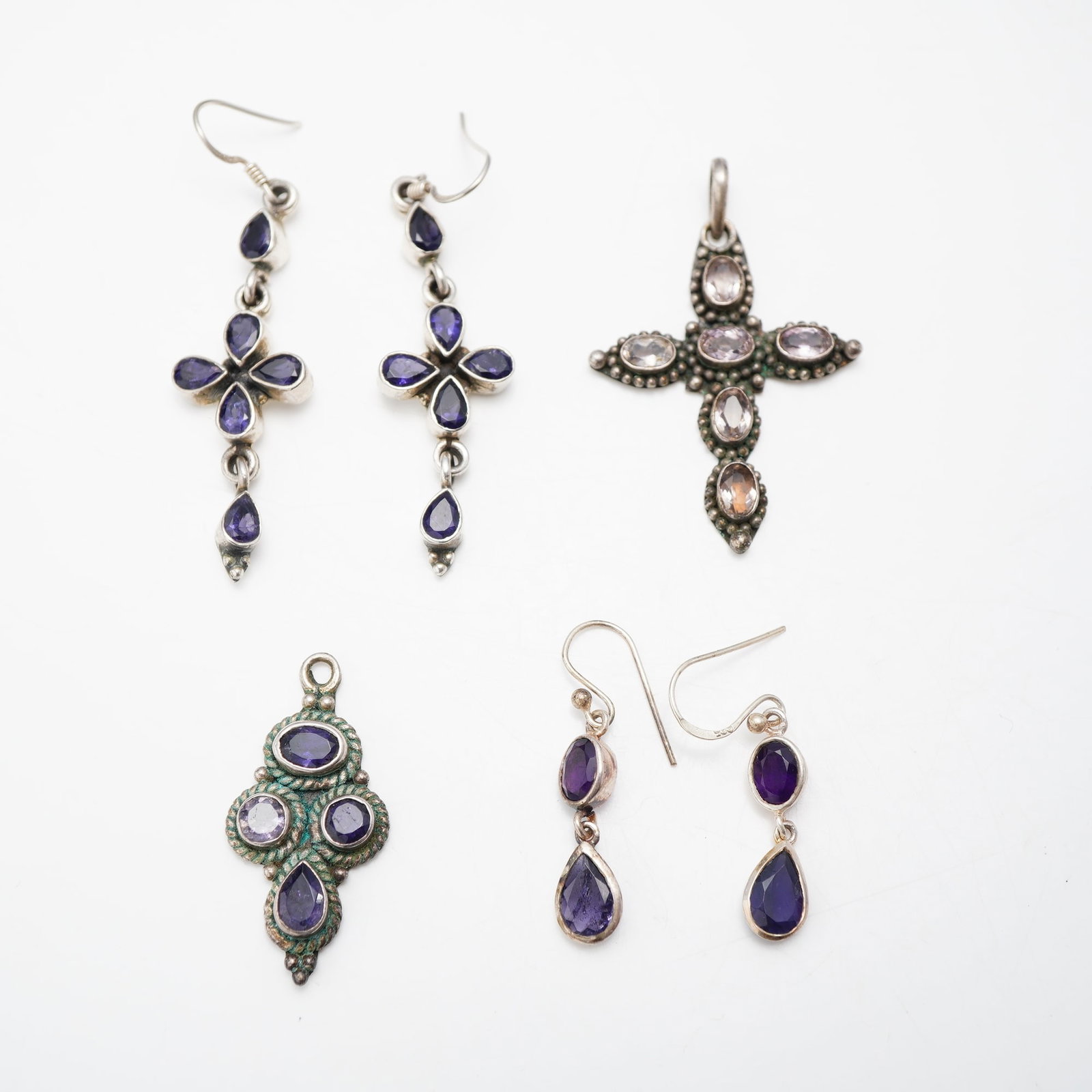 6pc Sterling Silver and Amethyst Jewelry Collection with Two Pairs of Earrings and Pendants: This 6pc collection of sterling silver gemstone jewelry features faceted purple stones consistent with amethyst. The assortment contains two pairs of drop earrings and two pendants. One pair of earrin