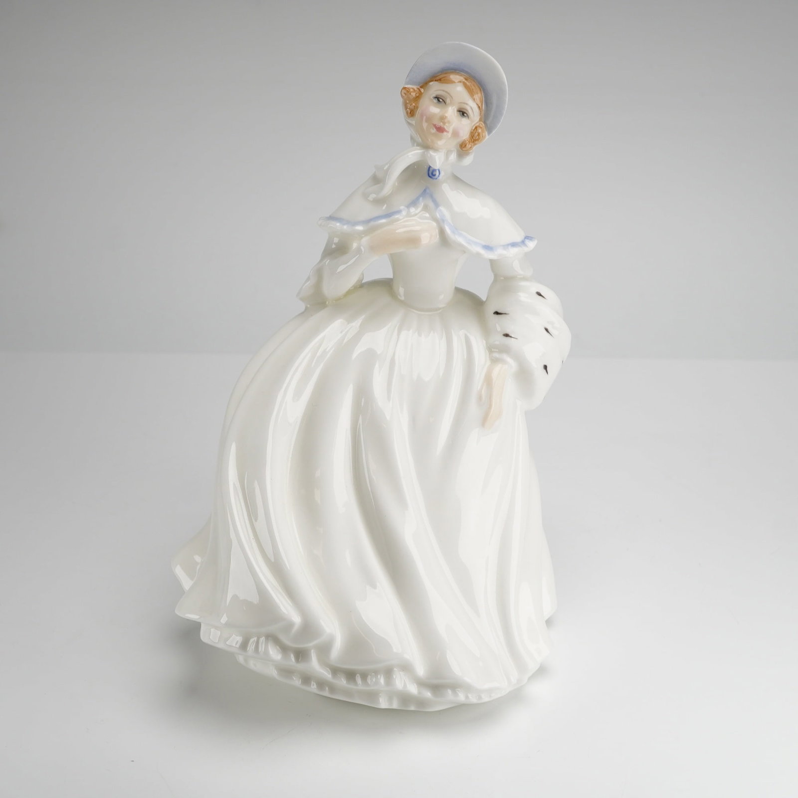 Royal Doulton Bone China Figurine, Jessica HN3497: This Royal Doulton bone china figurine, titled Jessica (HN3497), was modeled by Peggy Davies in a Victorian style. The hand-decorated figure is depicted in a voluminous white skirt with a matching whi