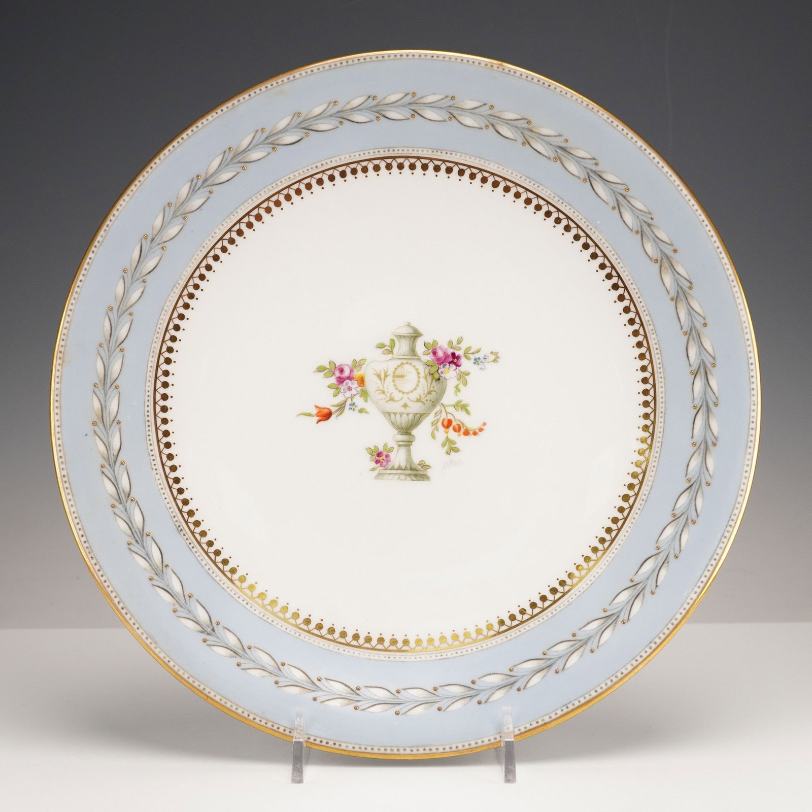 Wedgwood Hand-Painted Cabinet Plate, Urn & Flowers, Signed A. Hall, X7654: A Wedgwood hand-painted cabinet plate, crafted from fine bone china in a Neoclassical revival style. The circular plate features a central white field adorned with a polychrome transfer-printed and